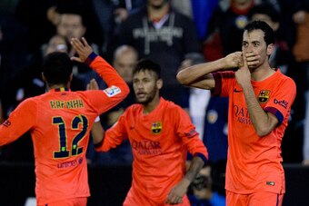 VALENCIA, SPAIN - NOVEMBER 30:  Sergio Busquets Burgos (R) of FC Barcelona celebrates scoring their opening goal with teammates Neymar JR. (2L) and Rafael Alcantara alias Rafinha (L) during the La Liga match between Valencia CF and FC Barcelona at Estadi 