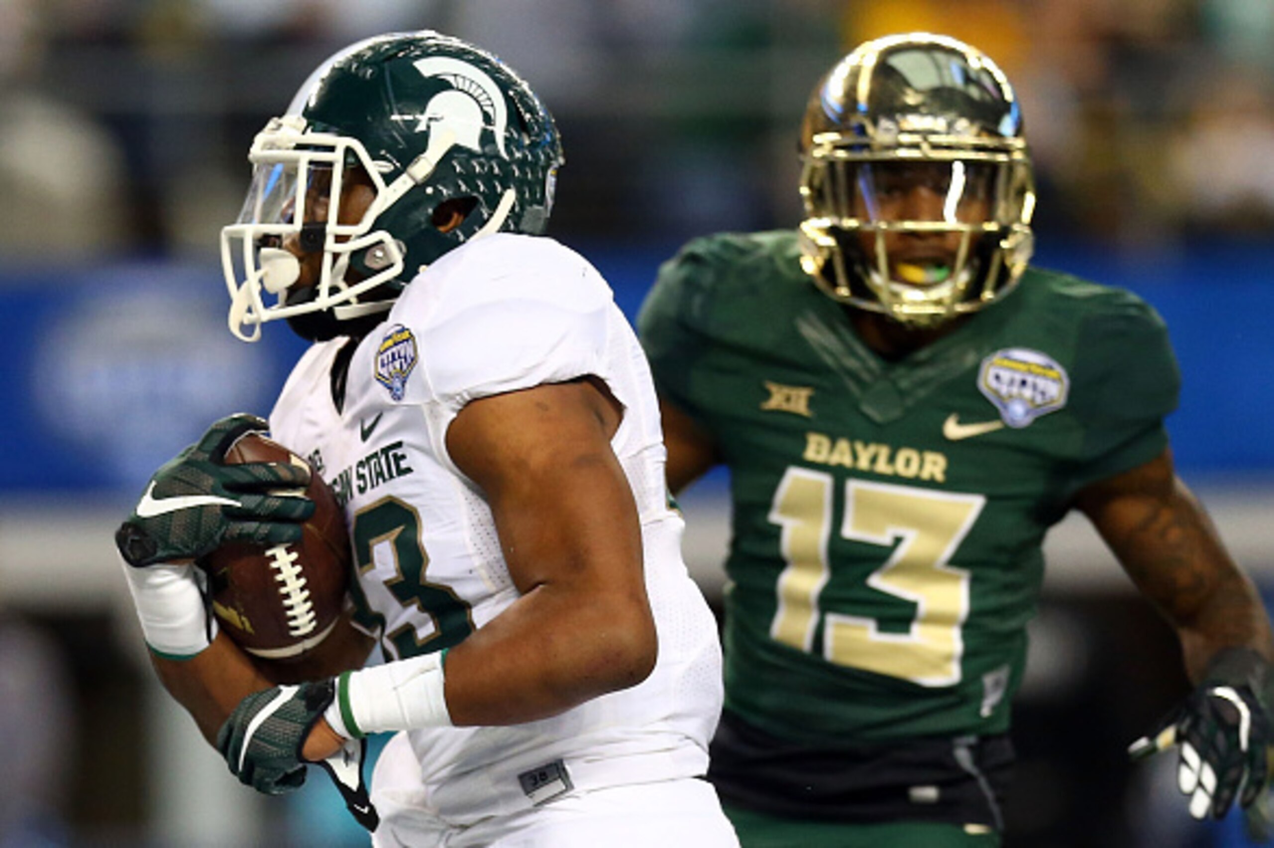 ARLINGTON, TX - JANUARY 01:  Jeremy Langford #33 of the Michigan State Spartans runs for a touchdown as Terrell Burt #13 of the Baylor Bears is near during the second half of the Goodyear Cotton Bowl Classic at AT&T Stadium on January 1, 2015 in Arlington