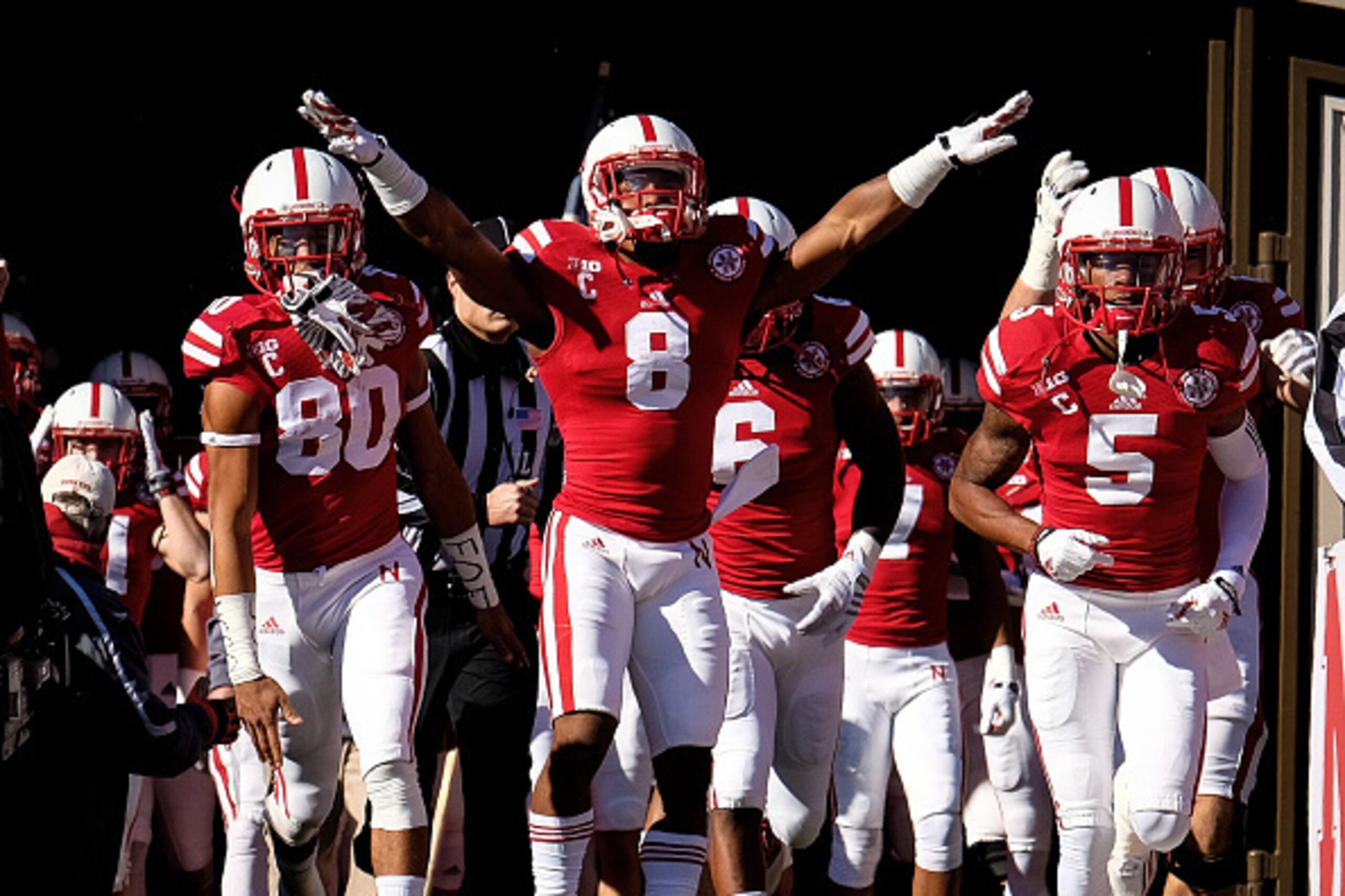 LINCOLN, NE - NOVEMBER 1: Wide receiver Kenny Bell, running back Ameer Abdullah and cornerback Josh Mitchell #5 of the Nebraska Cornhuskers lead the captains on the field before their game against the Purdue Boilermakers at Memorial Stadium on November 1,
