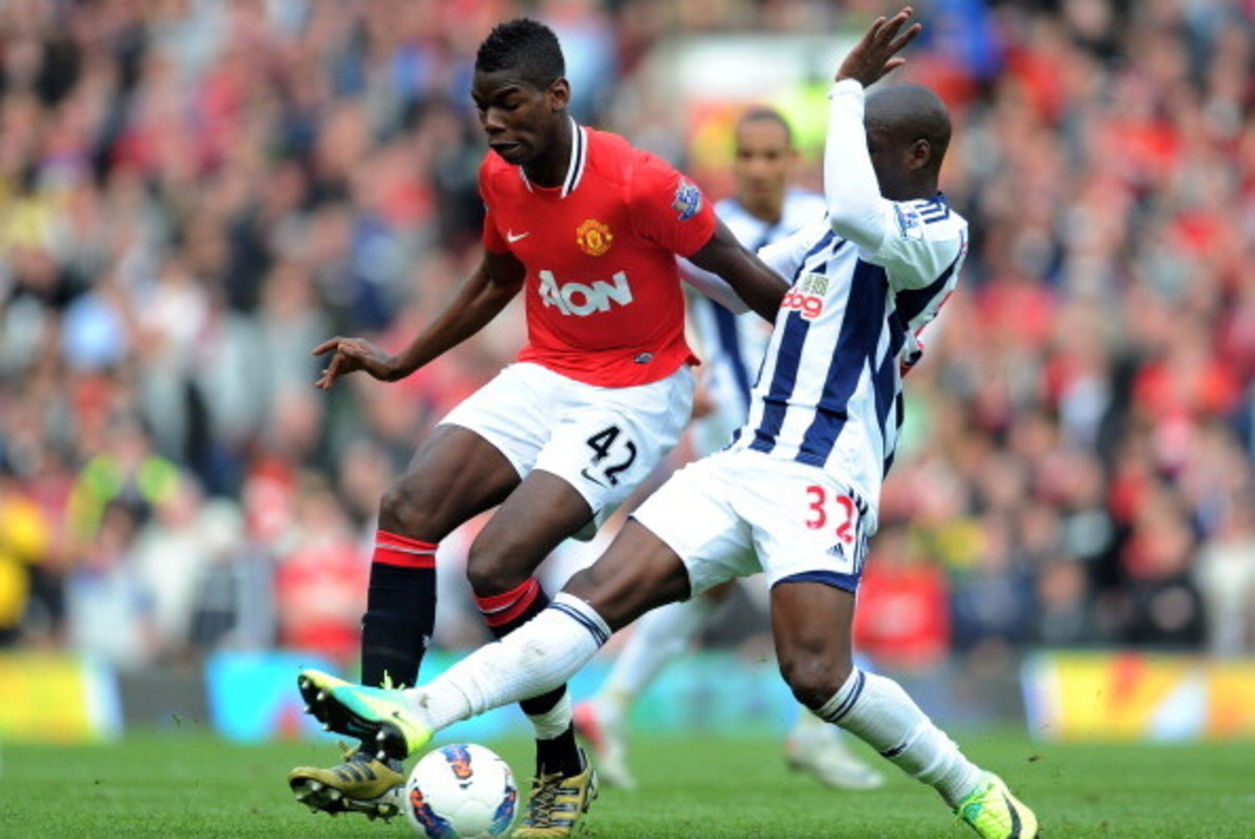 MANCHESTER, ENGLAND - MARCH 11:  Paul Pogba of Manchester United is challenged by Marc-Antoine Fortune of West Bromwich Albionduring the Barclays Premier League match between Manchester United and West Bromwich Albion at Old Trafford on March 11, 2012 in 