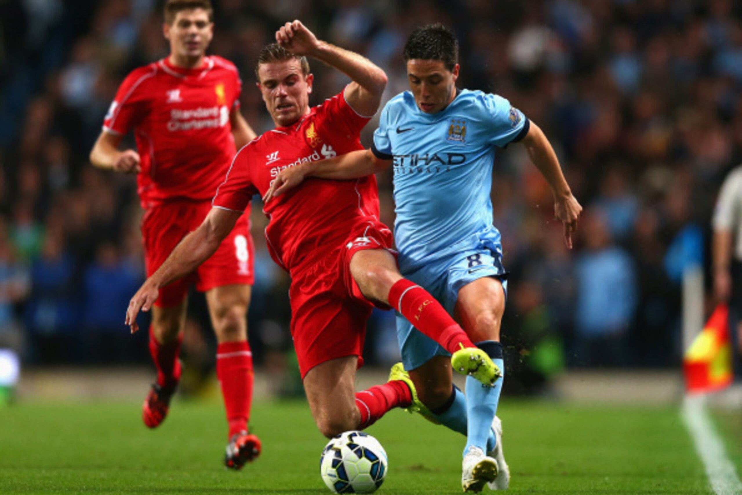 MANCHESTER, ENGLAND - AUGUST 25:  Jordan Henderson of Liverpool challenges Samir Nasri of Manchester City during the Barclays Premier League match between Manchester City and Liverpool at the Etihad Stadium on August 25, 2014 in Manchester, England.  (Pho