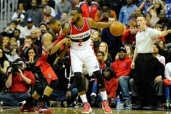 Jan 31, 2015; Washington, DC, USA; Washington Wizards guard John Wall (2) dribbles as Toronto Raptors guard Kyle Lowry (7) defends during the second half at Verizon Center. Toronto won 120 - 116. Mandatory Credit: Brad Mills-USA TODAY Sports