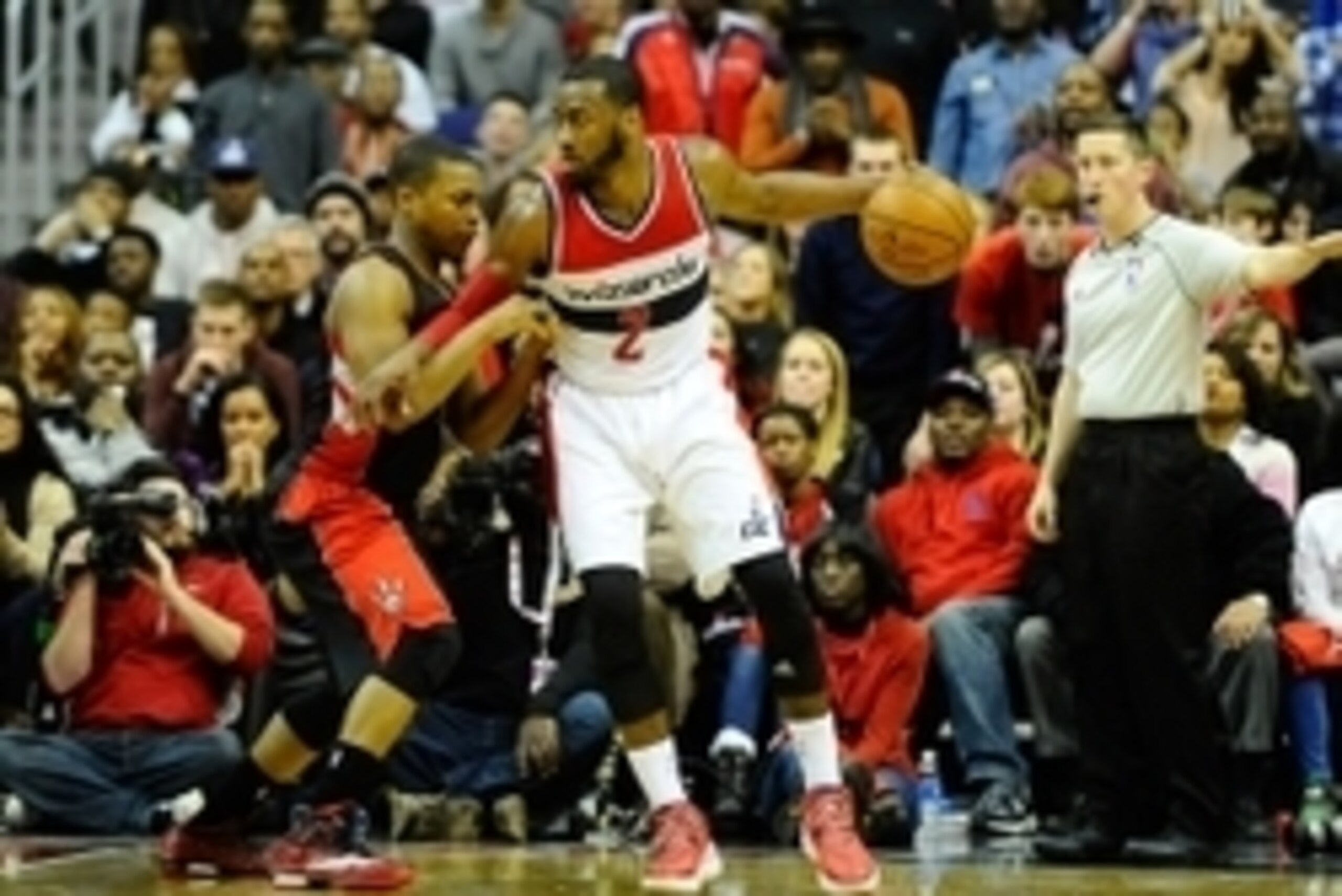 Jan 31, 2015; Washington, DC, USA; Washington Wizards guard John Wall (2) dribbles as Toronto Raptors guard Kyle Lowry (7) defends during the second half at Verizon Center. Toronto won 120 - 116. Mandatory Credit: Brad Mills-USA TODAY Sports