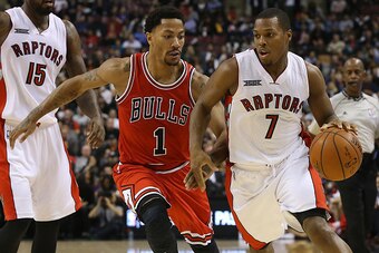 TORONTO,ON - NOVEMBER 13:  Kyle Lowry #7 of the Toronto Raptors drives to the basket as Derrick Rose #1 of the Chicago Bulls defends during their NBA game at the Air Canada Centre on November 13, 2014 in Toronto, Ontario, Canada. NOTE TO USER: User expres