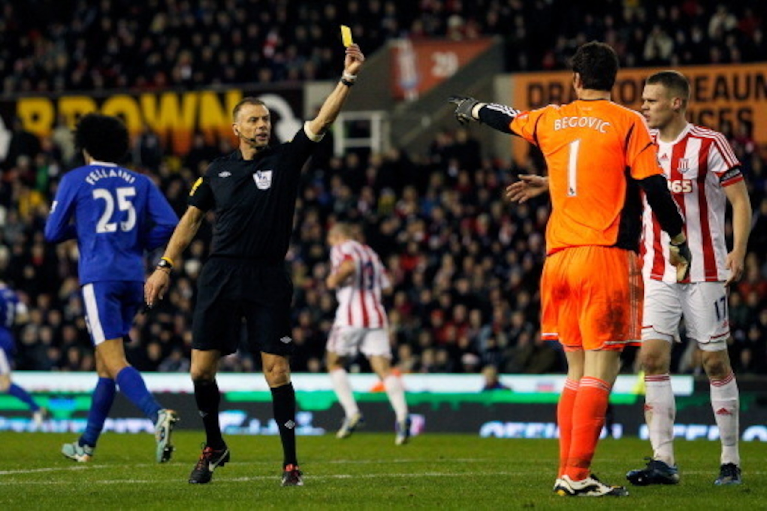 STOKE-ON-TRENT, ENGLAND - DECEMBER 15: Asmir Begovic of Stoke City receives a yellow card from referee Mark Halsey during the Barclays Premier League match between Stoke City and Everton at the Britannia Stadium on December 15, 2012, in Stoke-on-Trent, En