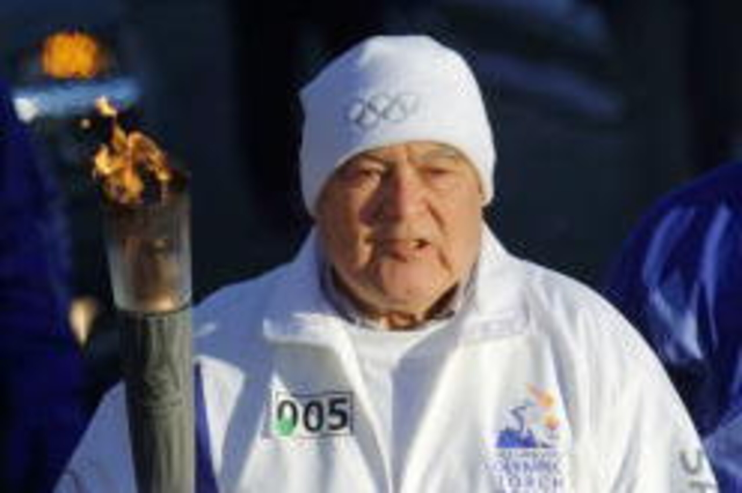 4 Jan 2002:  Torchbearer Father Theodore Hesburgh carries the Olympic Flame throught the University of Notre Dame campus during the 2002 Salt Lake Olympic Torch Relay in South Bend, Indiana. DIGITAL IMAGE.  Mandatory Credit: Todd Warshaw/Pool/Getty Images