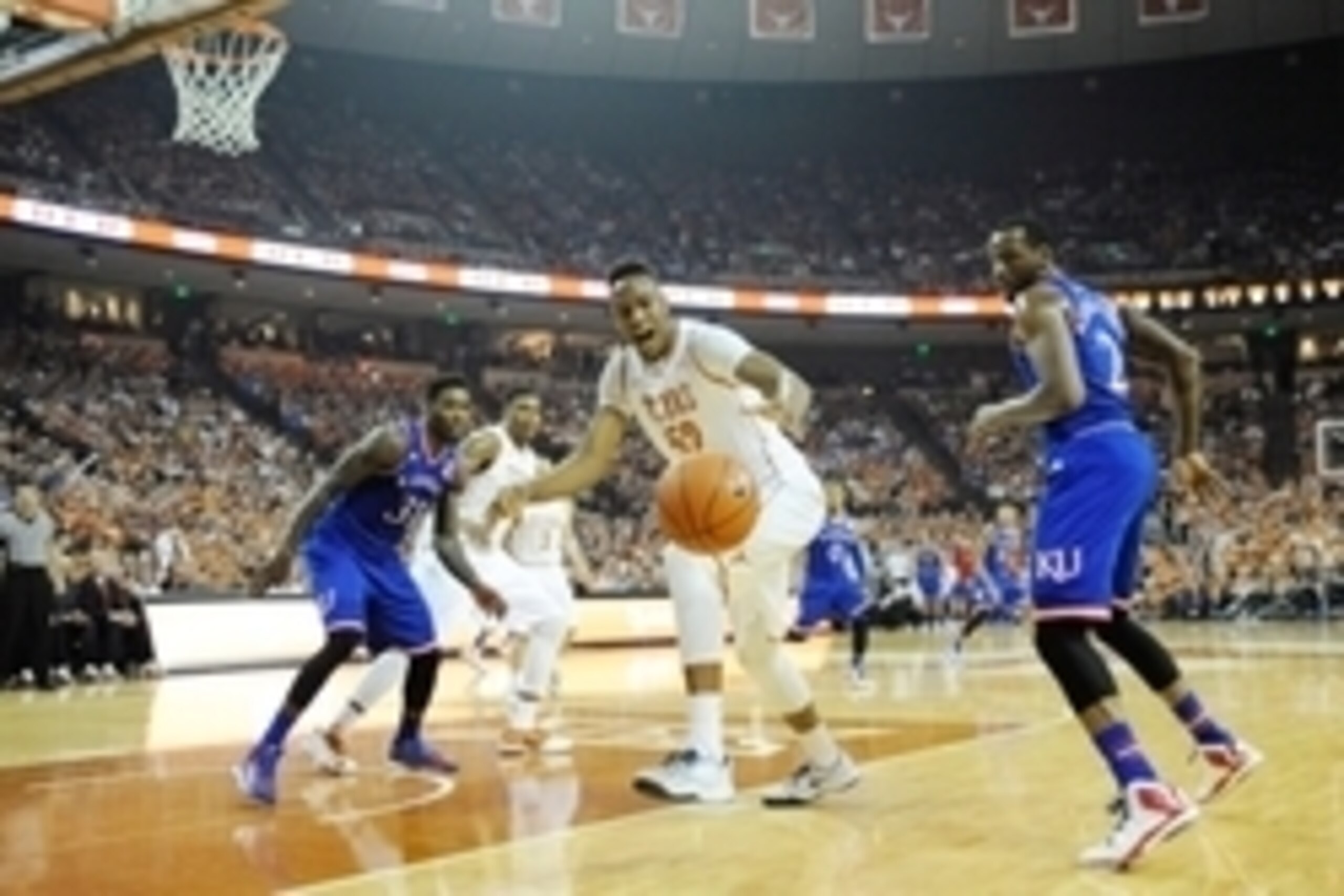 Jan 24, 2015; Austin, TX, USA; Texas Longhorns forward Myles Turner (52) rebounds against Kansas Jayhawks  forwards Jamari Traylor (left) and Cliff Alexander (2) during the first half at the Frank Erwin Special Events Center. Mandatory Credit: Brendan Mal