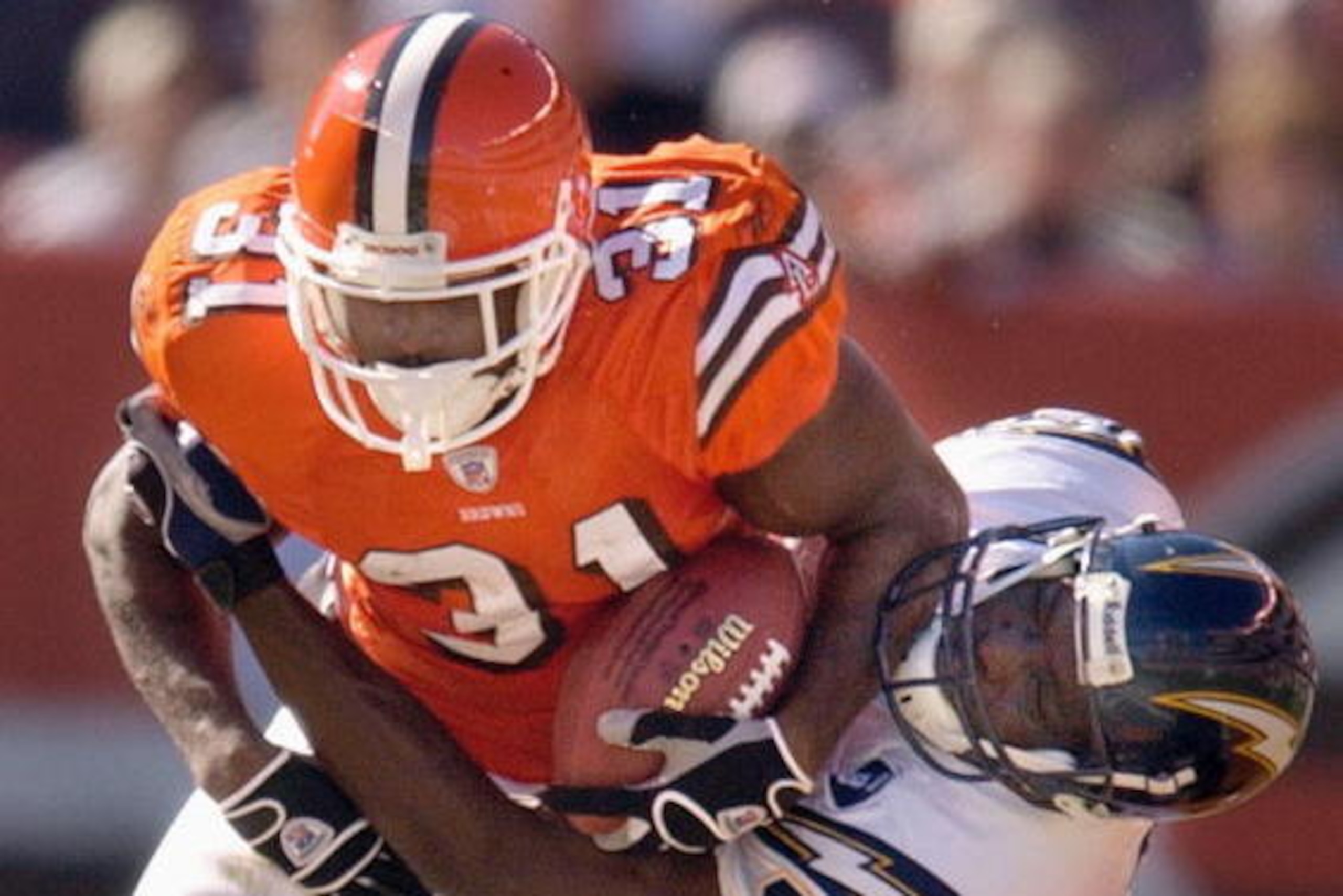 CLEVELAND, OH - OCTOBER 19:  Running back William Green #31 of the Cleveland Browns is tackled by safety Terrence Kiel #48 of the San Diego Chargers on October 19, 2003 at Cleveland Browns Stadium in Cleveland, Ohio. The Chargers defeated the Browns 26-20