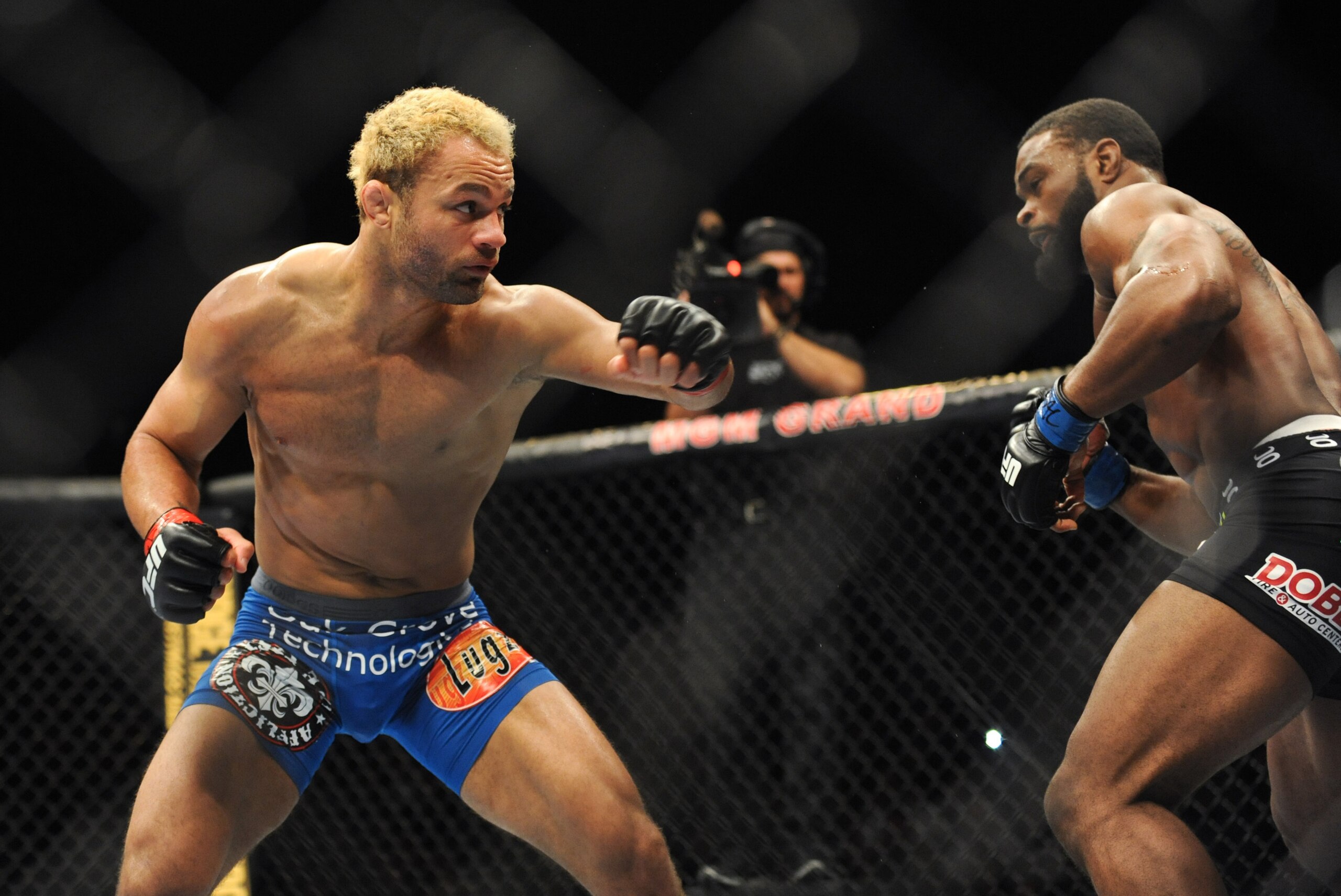 Nov 16, 2013; Las Vegas, NV, USA; Josh Koscheck (red gloves) fights against Tyron Woodley (blue gloves) in their welterweight bout during UFC 167 at MGM Grand Garden Arena. Mandatory Credit: Stephen R. Sylvanie-USA TODAY Sports