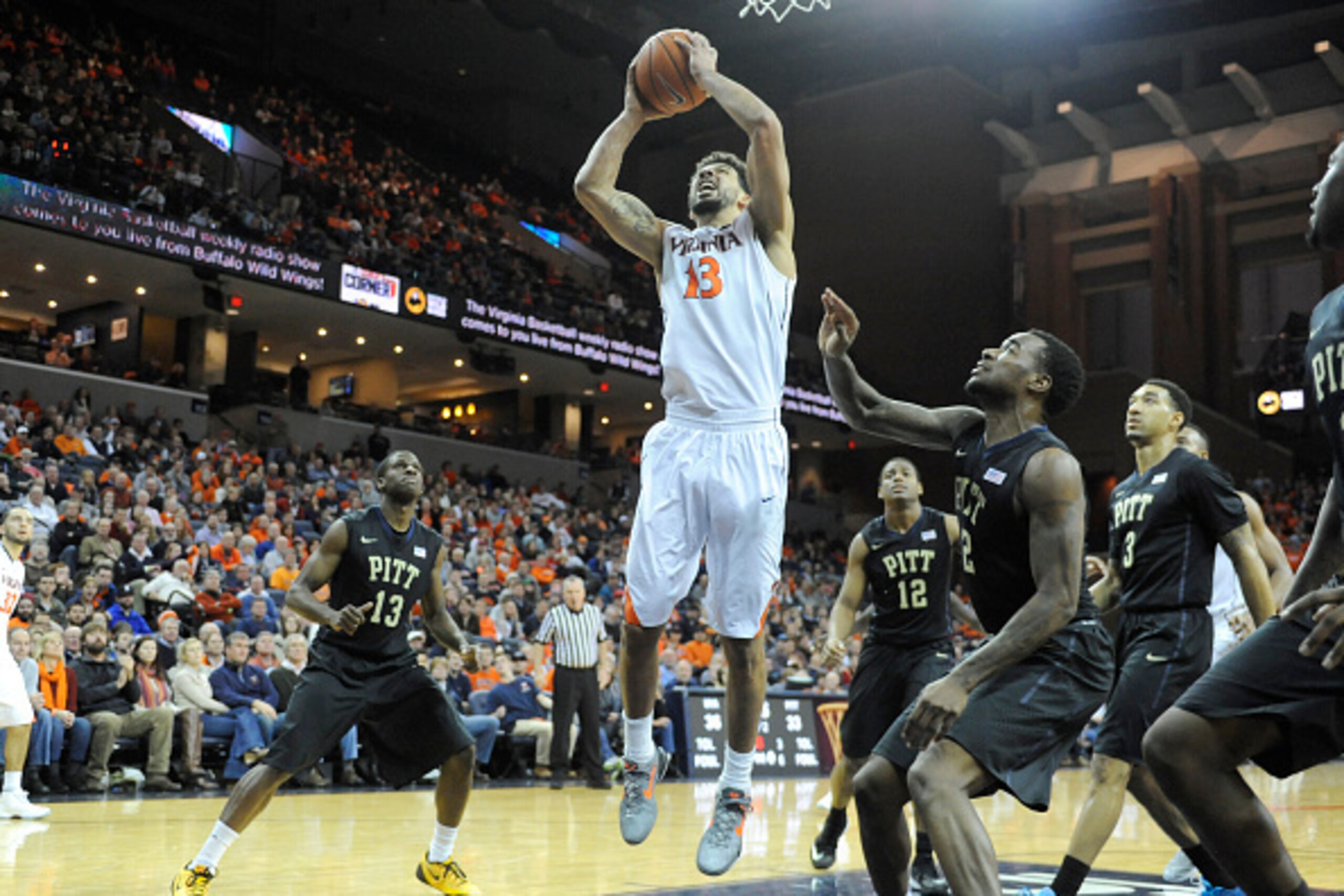 CHARLOTTESVILLE, VA - FEBRUARY 16:  Anthony Gill #13 of the Virginia Cavaliers drives to the basket during a college basketball game against the Pittsburgh Panthers at the John Paul Jones Arena on February 16, 2015 in Charlottesville, Virginia.  The Caval