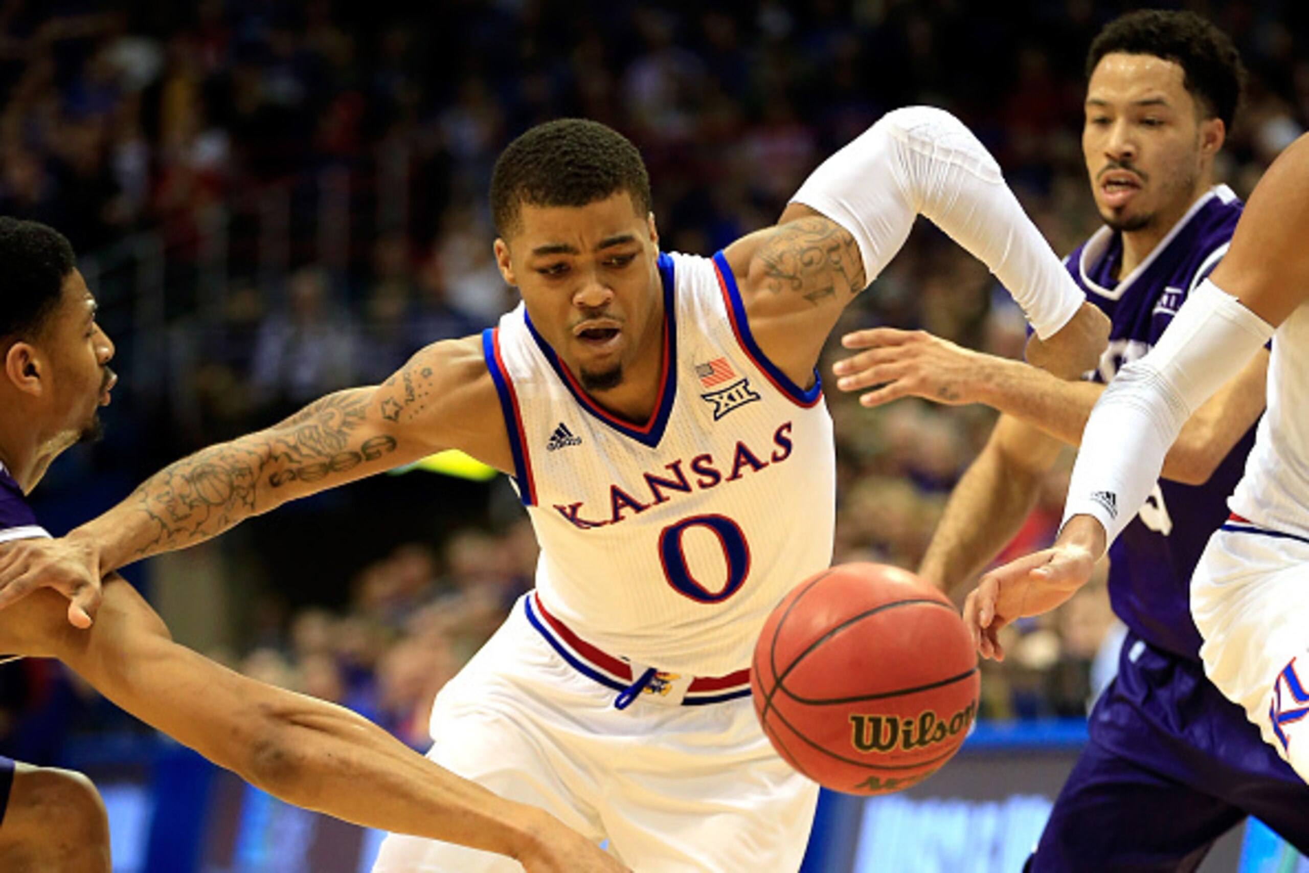 LAWRENCE, KS - FEBRUARY 21:  Frank Mason III #0 of the Kansas Jayhawks chases a loose ball during the game against the TCU Horned Frogs at Allen Fieldhouse on February 21, 2015 in Lawrence, Kansas.  (Photo by Jamie Squire/Getty Images)
