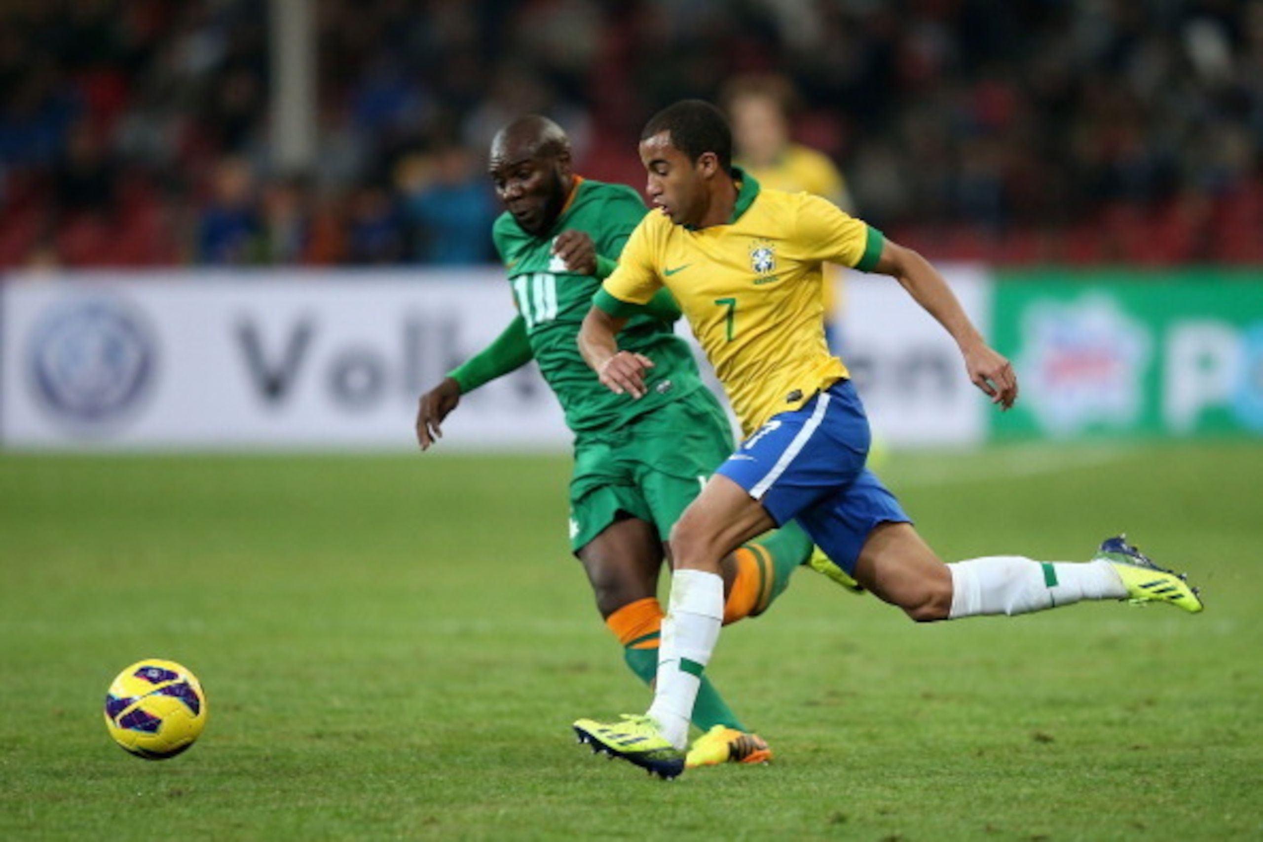 BEIJING, CHINA - OCTOBER 15: Lucas of Brazil (Right) competes the ball with Tembo Fwayo of Zambia (Left) during the international friendly match between Brazil and Zambia at Beijing National Stadium on October 15, 2013 in Beijing, China. (Photo by Feng BEIJING, CHINA - OCTOBER 15: Lucas of Brazil (Right) competes the ball with Tembo Fwayo of Zambia (Left) during the international friendly match between Brazil and Zambia at Beijing National Stadium on October 15, 2013 in Beijing, China. (Photo by Feng