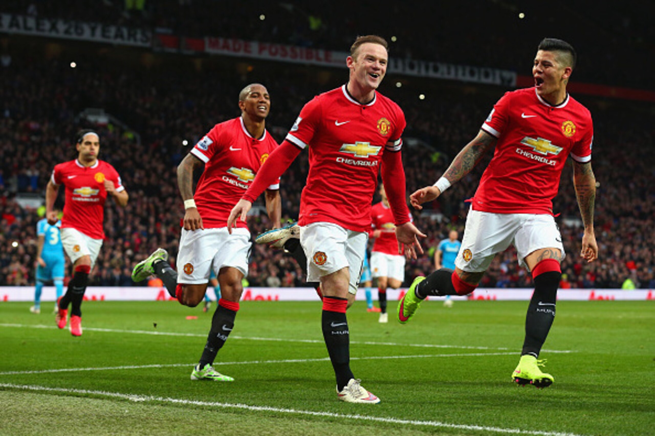 MANCHESTER, ENGLAND - FEBRUARY 28:  Wayne Rooney of Manchester United celebrates scoring the opening goal with Marcos Rojo and Ashley Young of Manchester United  during the Barclays Premier League match between Manchester United and Sunderland at Old Traf