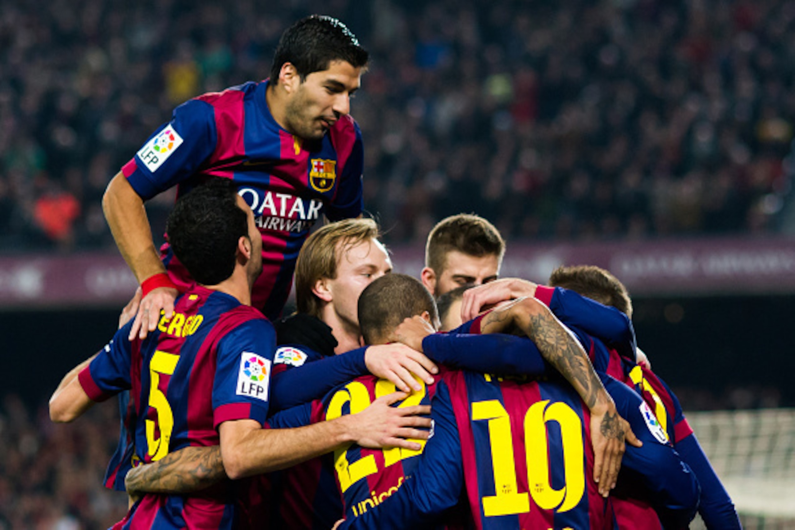 BARCELONA, SPAIN - JANUARY 11: Luis Suarez (top) of FC Barcelona celebrates with his teammates after Neymar Santos Jr scored his team's first goal during the La Liga match between FC Barcelona and Club Atletico de Madrid at Camp Nou on January 11, 2015 in BARCELONA, SPAIN - JANUARY 11: Luis Suarez (top) of FC Barcelona celebrates with his teammates after Neymar Santos Jr scored his team's first goal during the La Liga match between FC Barcelona and Club Atletico de Madrid at Camp Nou on January 11, 2015 in