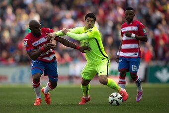 GRANADA, SPAIN - FEBRUARY 28:  Luis Suarez (R) of FC Barcelona competes for the ball Jean-Sylvain Babin of Granada CF during the La Liga match between Granada CF and FC Barcelona at Nuevo Estadio de los Carmenes on February 28, 2015 in Granada, Spain.  (P
