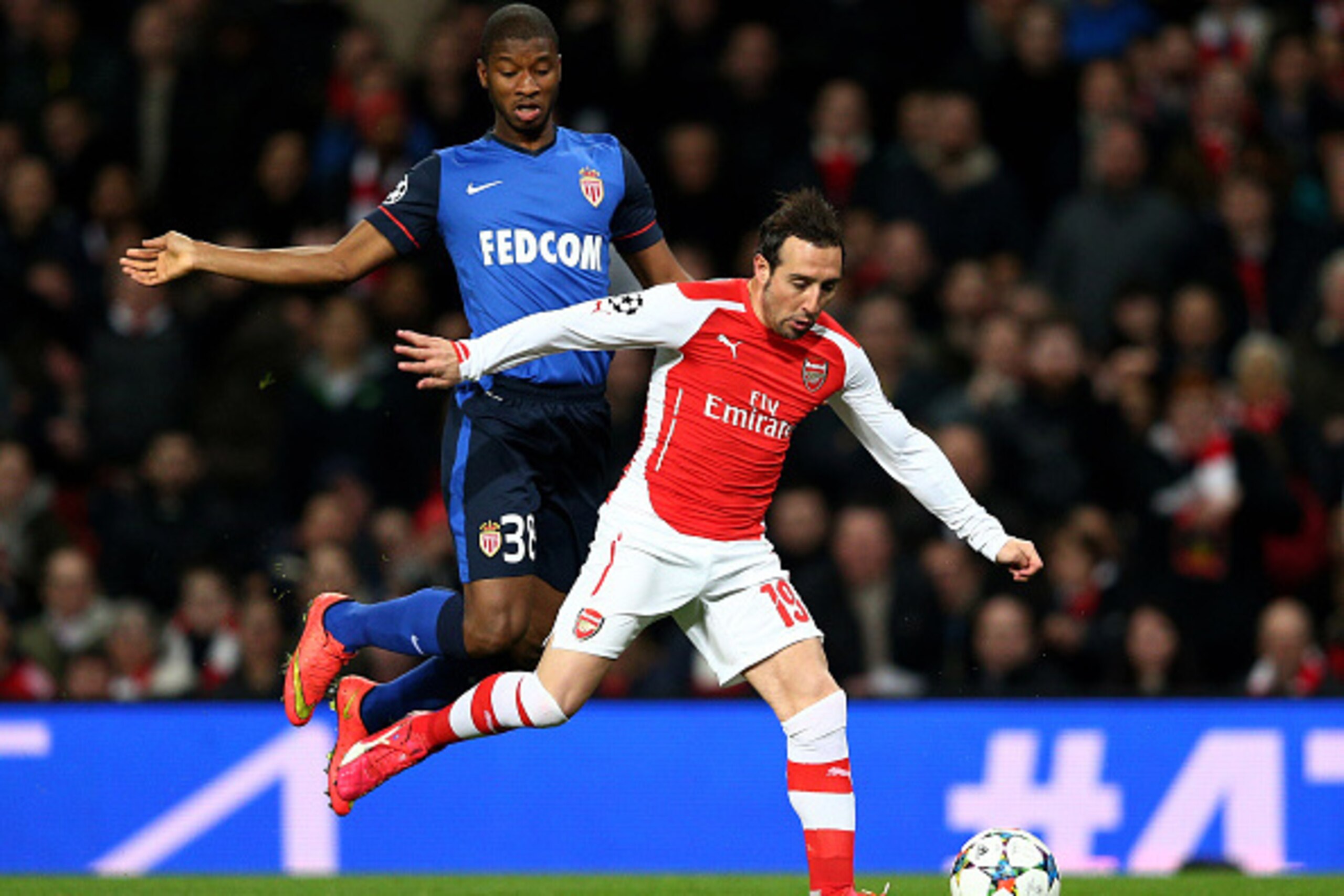 LONDON, ENGLAND - FEBRUARY 25:  Santi Cazorla of Arsenal is challenged by Almary Toure of Monaco during the UEFA Champions League round of 16, first leg match between Arsenal and Monaco at The Emirates Stadium on February 25, 2015 in London, United Kingdo