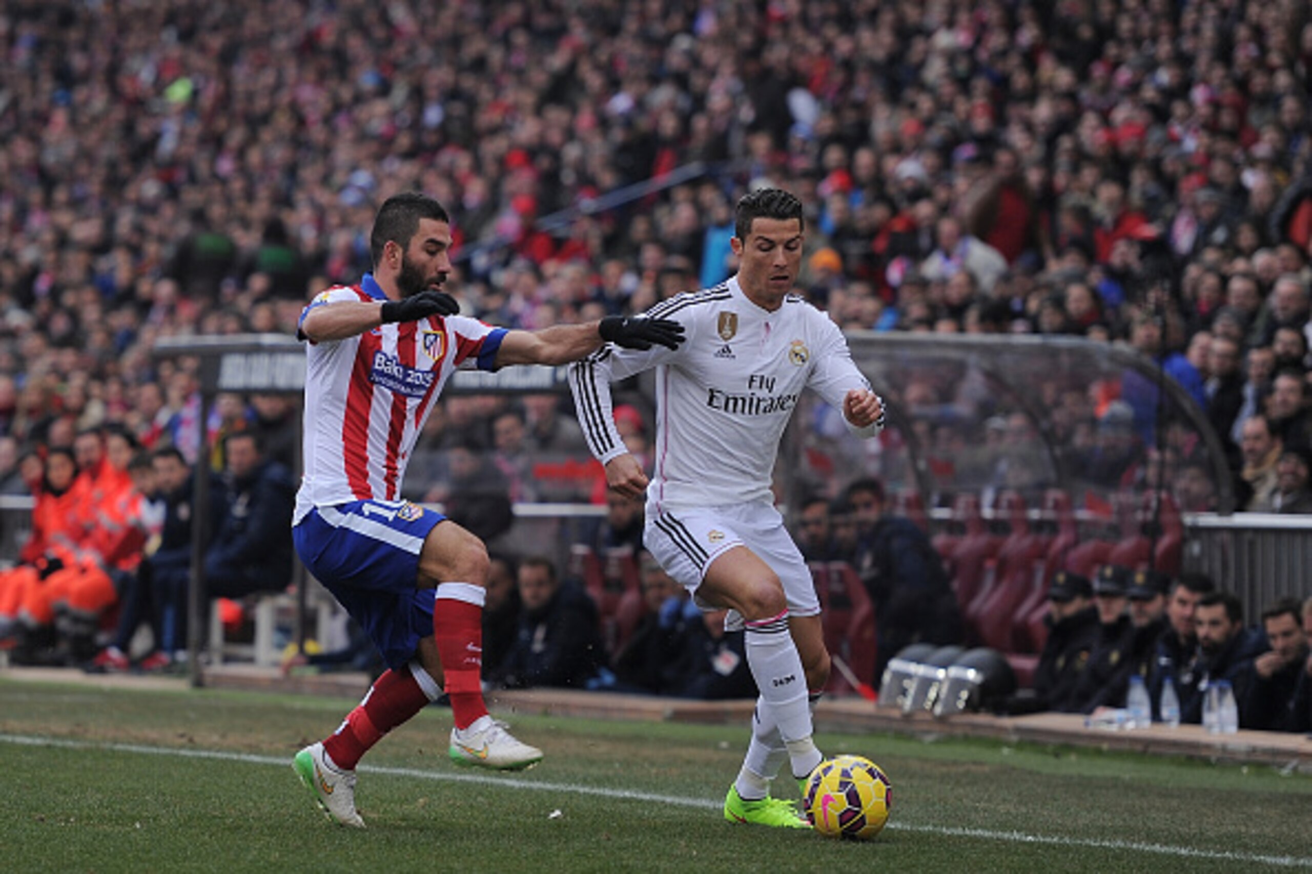MADRID, SPAIN - FEBRUARY 07: Cristiano Ronaldo of Real Madrid
is tackled by Arda Turan of Club Atletico de Madrid during the La Liga match between Club Atletico de Madrid and Real Madrid at Vicente Calderon Stadium on February 7, 2015 in Madrid, Spain. MADRID, SPAIN - FEBRUARY 07: Cristiano Ronaldo of Real Madrid
is tackled by Arda Turan of Club Atletico de Madrid during the La Liga match between Club Atletico de Madrid and Real Madrid at Vicente Calderon Stadium on February 7, 2015 in Madrid, Spain.