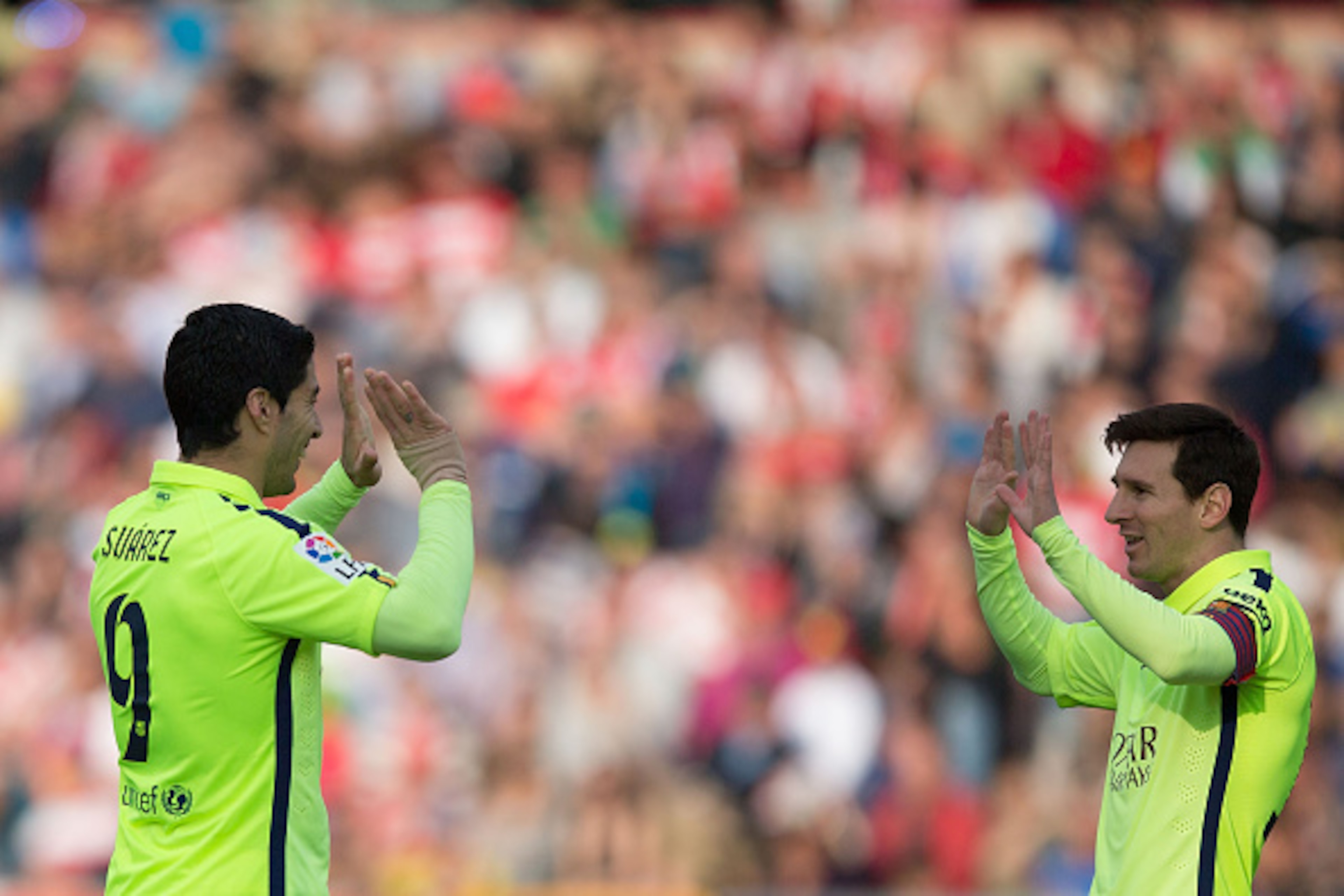 GRANADA, SPAIN - FEBRUARY 28:  Lionel Messi (R) of FC Barcelona celebrates scoring their third goal with teammate Luis Suarez (L) during the La Liga match between Granada CF and FC Barcelona at Nuevo Estadio de los Carmenes on February 28, 2015 in Granada