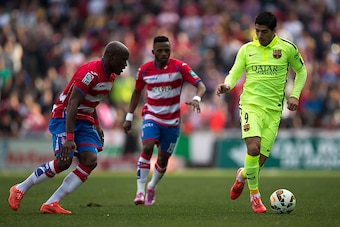 GRANADA, SPAIN - FEBRUARY 28:  Luis Suarez (R) of FC Barcelona competes for the ball Jean-Sylvain Babin of Granada CF during the La Liga match between Granada CF and FC Barcelona at Nuevo Estadio de los Carmenes on February 28, 2015 in Granada, Spain.  (P