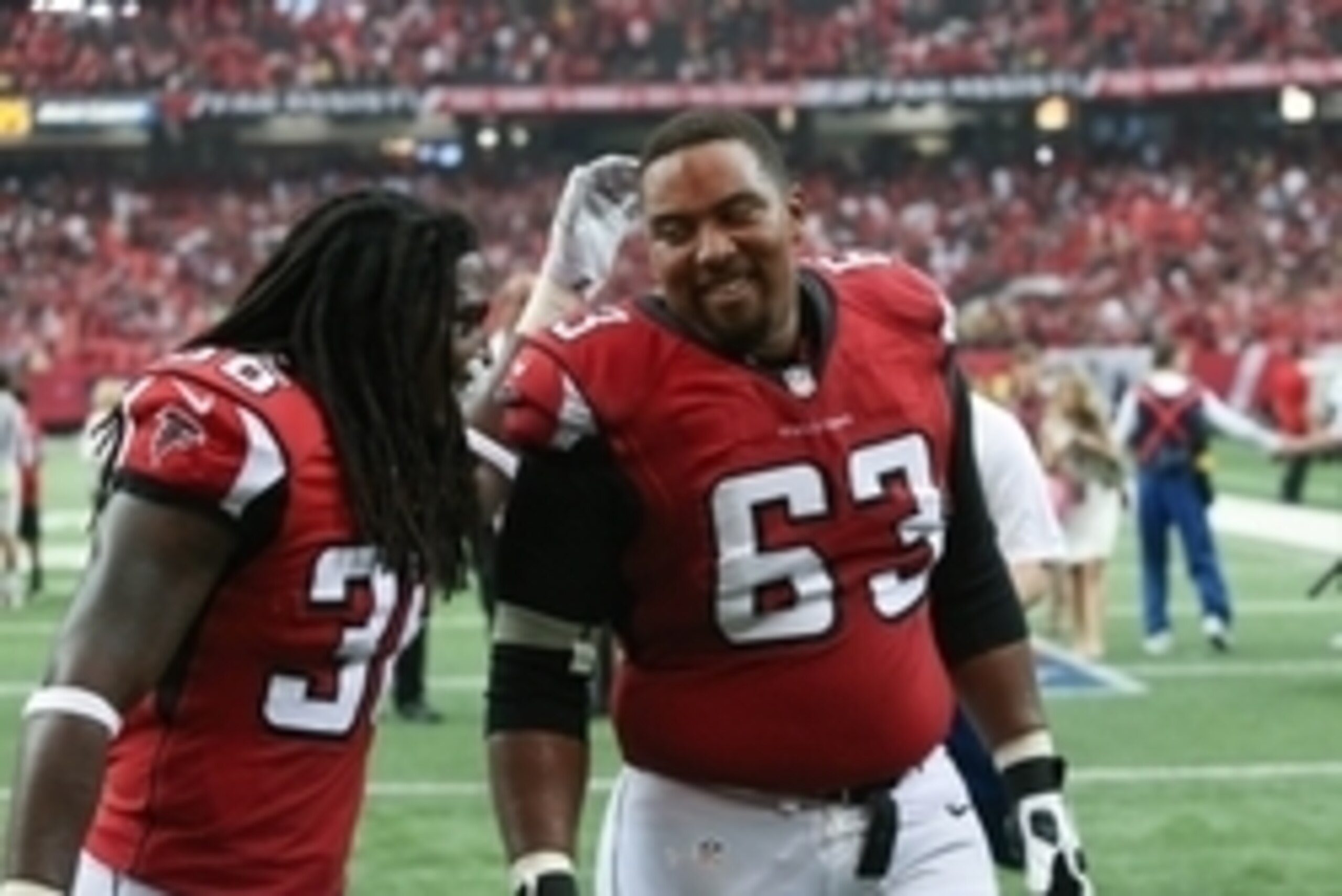 Sep 7, 2014; Atlanta, GA, USA; Atlanta Falcons defensive back Kemal Ishmael (36) celebrates with Atlanta Falcons guard Justin Blalock (63) after their win over the New Orleans Saints at the Georgia Dome. The Falcons won 37-34 in overtime. Mandatory Credit