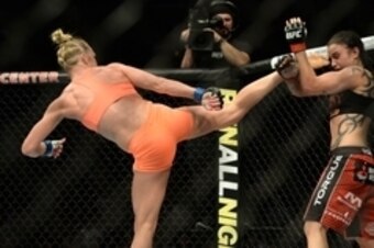 Feb 28, 2015; Los Angeles, CA, USA; Raquel Pennington (red gloves) and Holly Holm (blue gloves) during their women's bantamweight bout at UFC 184 at Staples Center. Mandatory Credit: Jayne Kamin-Oncea-USA TODAY Sports