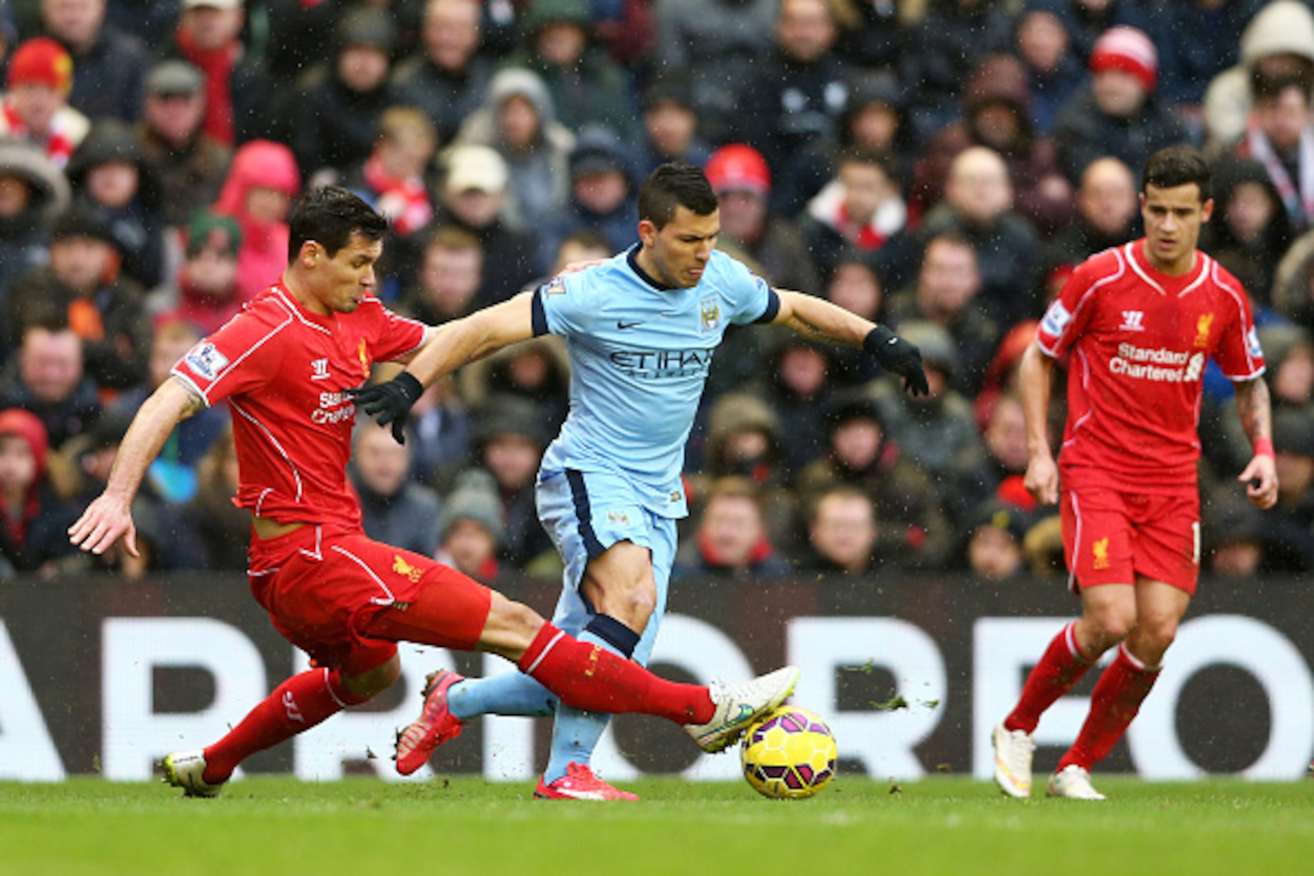 LIVERPOOL, ENGLAND - MARCH 01:  Sergio Aguero of Manchester City is tackled by Dejan Lovren of Liverpool during the Barclays Premier League match between Liverpool and Manchester City at Anfield on March 1, 2015 in Liverpool, England.  (Photo by Clive Bru