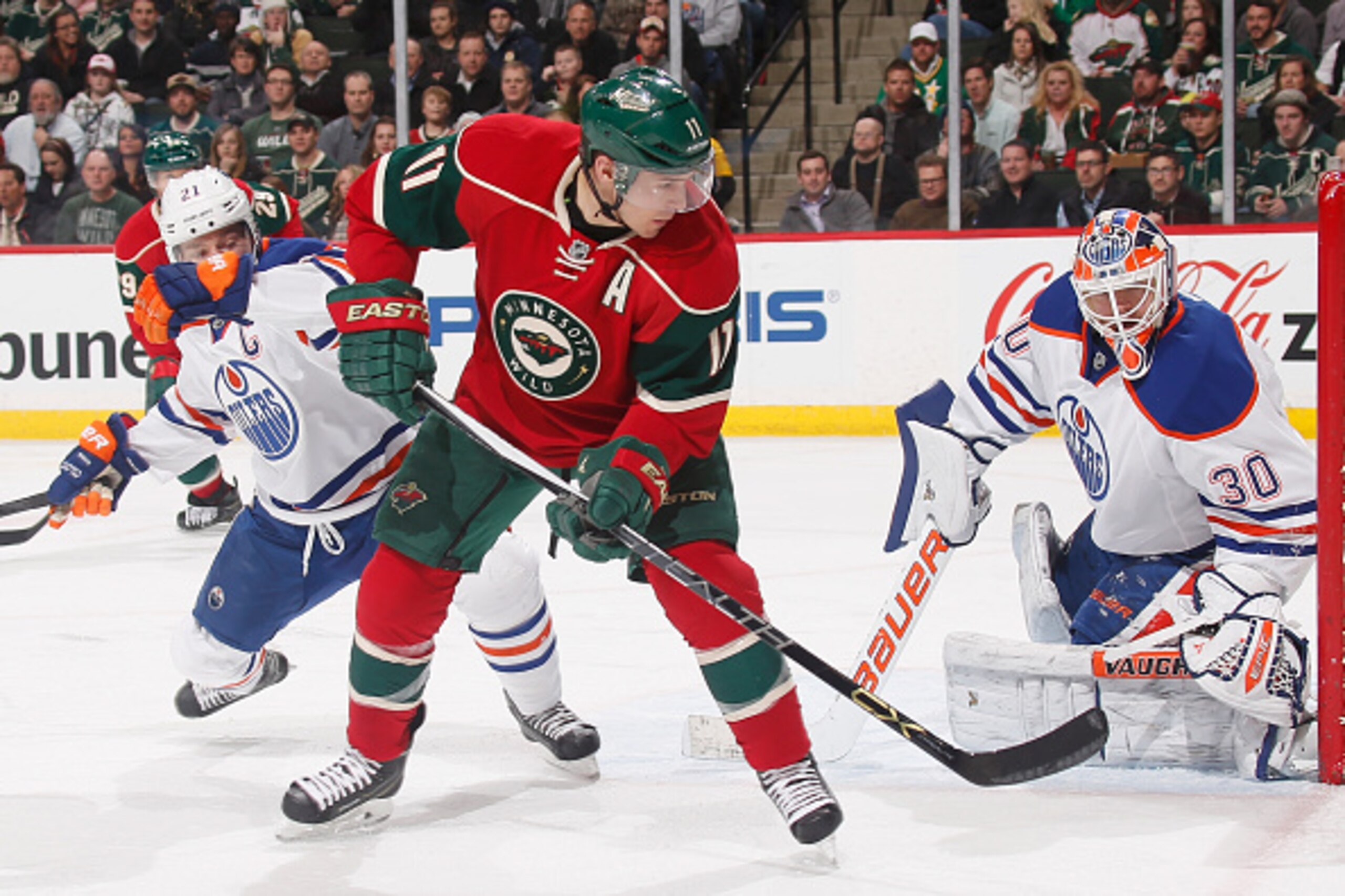 ST. PAUL, MN - FEBRUARY 24: (L-R) Andrew Ference #21 and Ben Scrivens #30 of the Edmonton Oilers defend against Zach Parise #11 of the Minnesota Wild during the game on February 24, 2015 at the Xcel Energy Center in St. Paul, Minnesota. (Photo by Bruce Kl