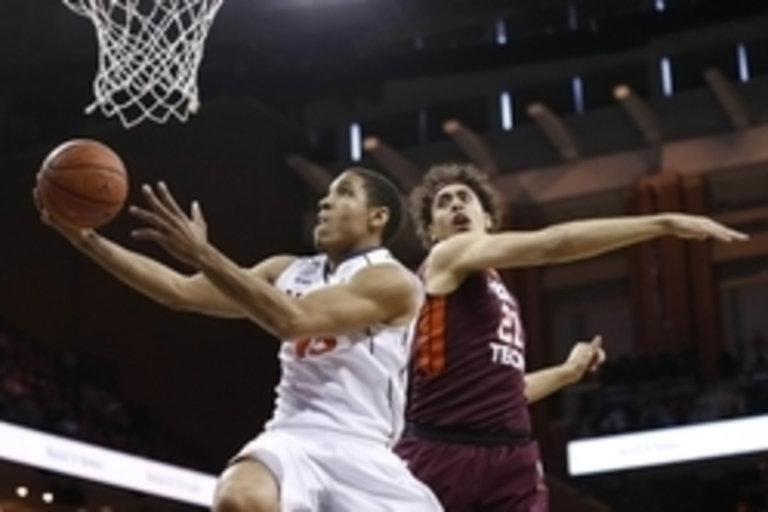 Feb 28, 2015; Charlottesville, VA, USA; Virginia Cavaliers guard Malcolm Brogdon (15) shoots the ball as Virginia Tech Hokies forward Satchel Pierce (21) defends in the second half at John Paul Jones Arena. The Cavaliers won 69-57. Mandatory Credit: Geoff