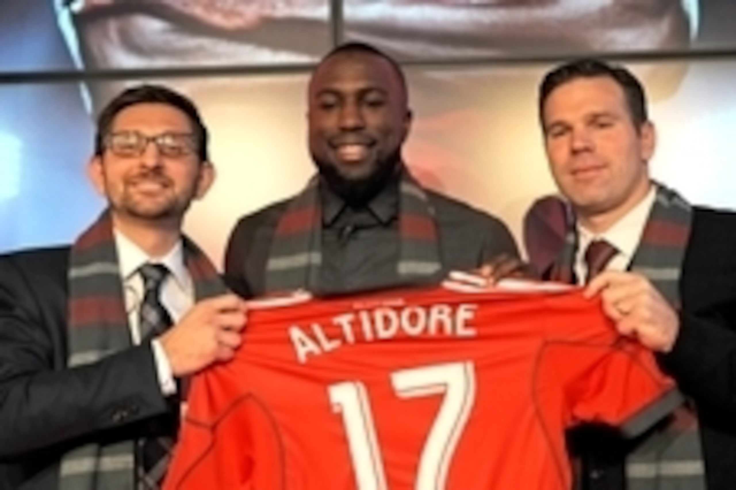 Jan 16, 2015; Toronto, ON, Canada;  Toronto FC striker Jozy Altidore is presented with his Toronto FC team jersey by club general manager Tim Bezbatchenko (left) and head coach Greg Vanney (right) during a media conference at Air Canada Centre. Mandatory 