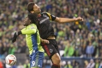 Nov 30, 2014; Seattle, WA, USA; Seattle Sounders FC forward Obafemi Martins (9) goes for a header with Los Angeles Galaxy defender Omar Gonzalez (4) during the second half of the Western Conference Championship at CenturyLink Field. Mandatory Credit: Joe 