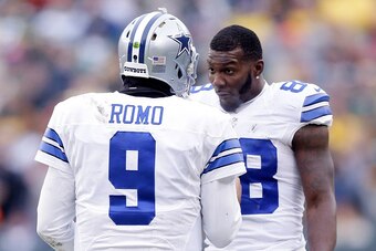 GREEN BAY, WI - JANUARY 11:  Quarterback  Tony Romo #9 and  Dez Bryant #88 of the Dallas Cowboys wait for the call on an instant replay during the 2015 NFC Divisional Playoff game against the Green Bay Packers at Lambeau Field on January 11, 2015 in Green
