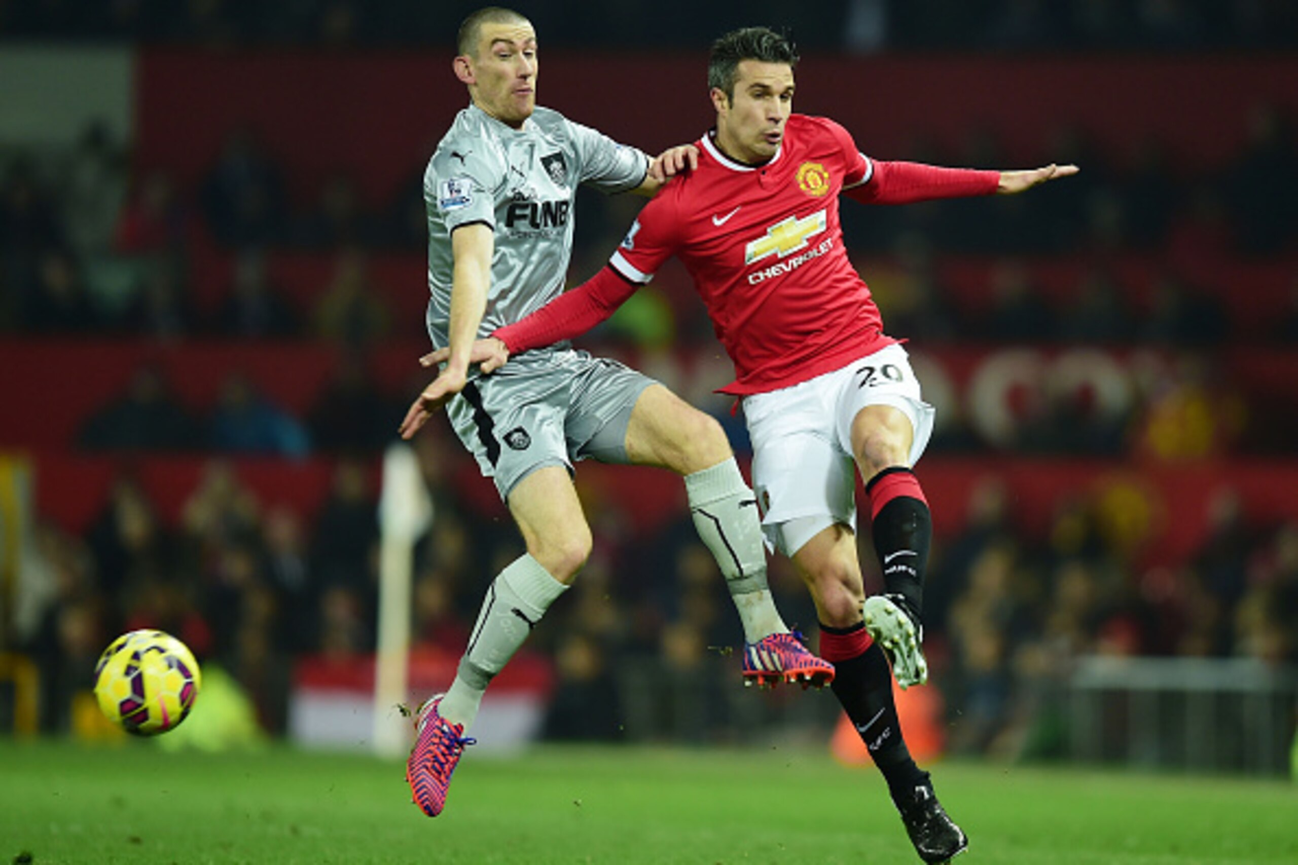 MANCHESTER, ENGLAND - FEBRUARY 11:  Robin van Persie of Manchester United is challenged by David Jones of Burnley during the Barclays Premier League match between Manchester United and Burnley at Old Trafford on February 11, 2015 in Manchester, England.  