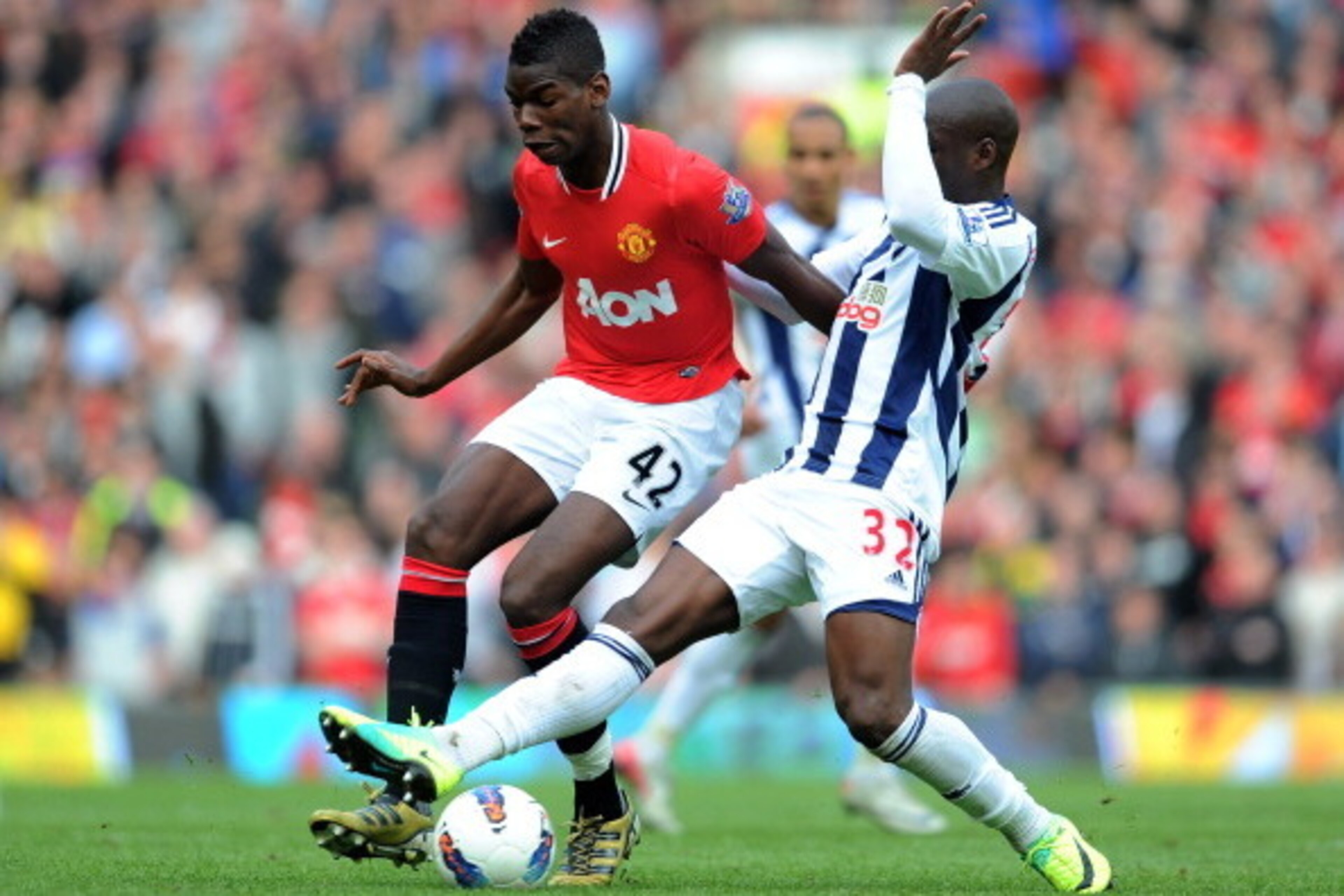 MANCHESTER, ENGLAND - MARCH 11: Paul Pogba of Manchester United is challenged by Marc-Antoine Fortune of West Bromwich Albionduring the Barclays Premier League match between Manchester United and West Bromwich Albion at Old Trafford on March 11, 2012 in MANCHESTER, ENGLAND - MARCH 11: Paul Pogba of Manchester United is challenged by Marc-Antoine Fortune of West Bromwich Albionduring the Barclays Premier League match between Manchester United and West Bromwich Albion at Old Trafford on March 11, 2012 in