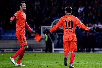 LA CORUNA, SPAIN - JANUARY 18:  Lionel Messi (R)of FC Barcelona celebrates scoring their third goal with teammate Sergio Busquets Burgos (L)during the La Liga match between RC Deportivo La Coruna and FC Ba rcelona at Riazor Stadium on January 18, 2015 in 