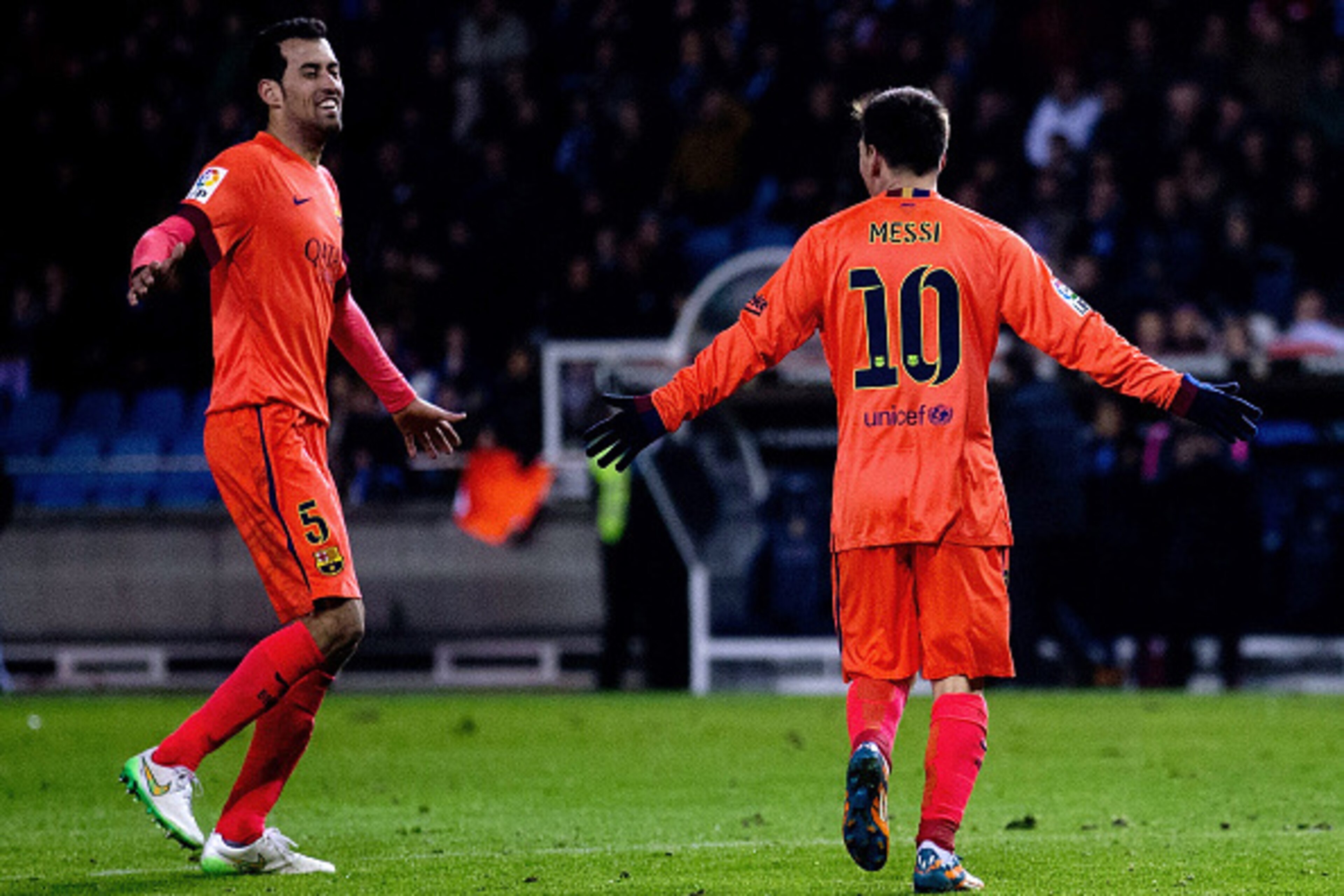 LA CORUNA, SPAIN - JANUARY 18:  Lionel Messi (R)of FC Barcelona celebrates scoring their third goal with teammate Sergio Busquets Burgos (L)during the La Liga match between RC Deportivo La Coruna and FC Ba rcelona at Riazor Stadium on January 18, 2015 in 
