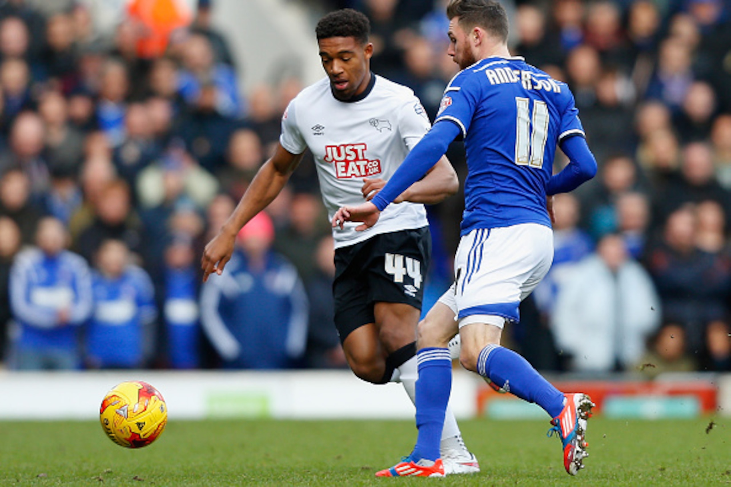 IPSWICH, ENGLAND - JANUARY 10: Jordon Ibe of Derby County (L) and Paul Anderson of Ipswich battle for the ball during the Sky Bet Championship match between Ipswich Town and Derby County at Portman Road on January 10, 2015 in Ipswich, England.  (Photo by 