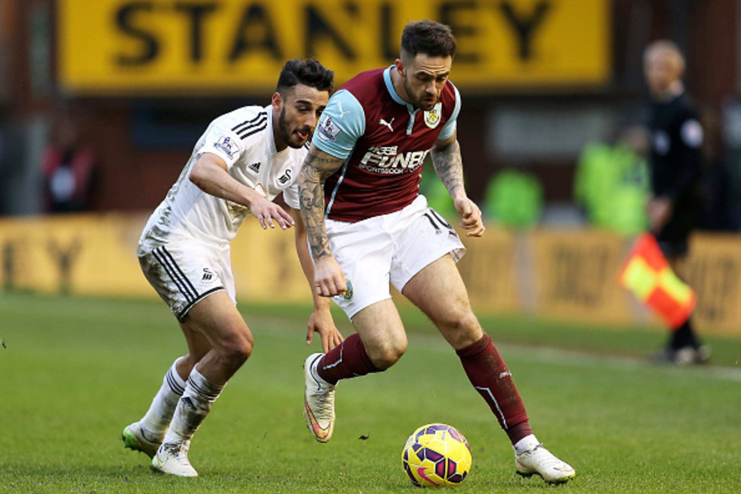 BURNLEY, ENGLAND - FEBRUARY 28:  Danny Ings of Burnley goes past Neil Taylor of Swansea City during the Barclays Premier League match between Burnley and Swansea City at Turf Moor on February 28, 2015 in Burnley, England.  (Photo by Jan Kruger/Getty Image