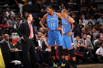 SAN ANTONIO, TX - DECEMBER 21:  Scott Brooks, Kevin Durant #35 and Russell Westbrook #0 of the Oklahoma City Thunder talk during the game against the San Antonio Spurs on December 21, 2013 at AT&T Arena in San Antonio Texas, Texas. NOTE TO USER: User expr