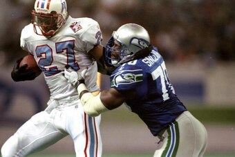 29 Nov 1998:  Running back Eddie George #27 of the Tennessee Oilers in action against defensive end Michael Sinclair #70 of the Seattle Seahawks during a game at the Kingdome in Seattle, Washington. The Seahawks defeated the Oilers 20-18. Mandatory Credit