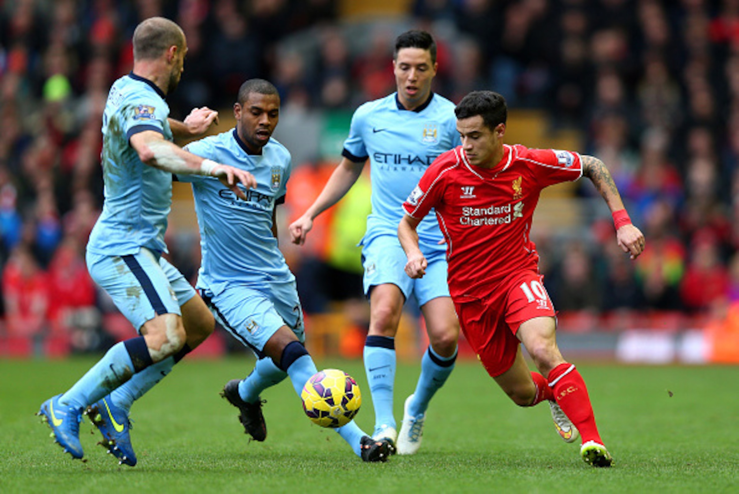 LIVERPOOL, ENGLAND - MARCH 01:  Philippe Coutinho of Liverpool is closed down by Manchester City defence during the Barclays Premier League match between Liverpool and Manchester City at Anfield on March 1, 2015 in Liverpool, England.  (Photo by Clive Bru