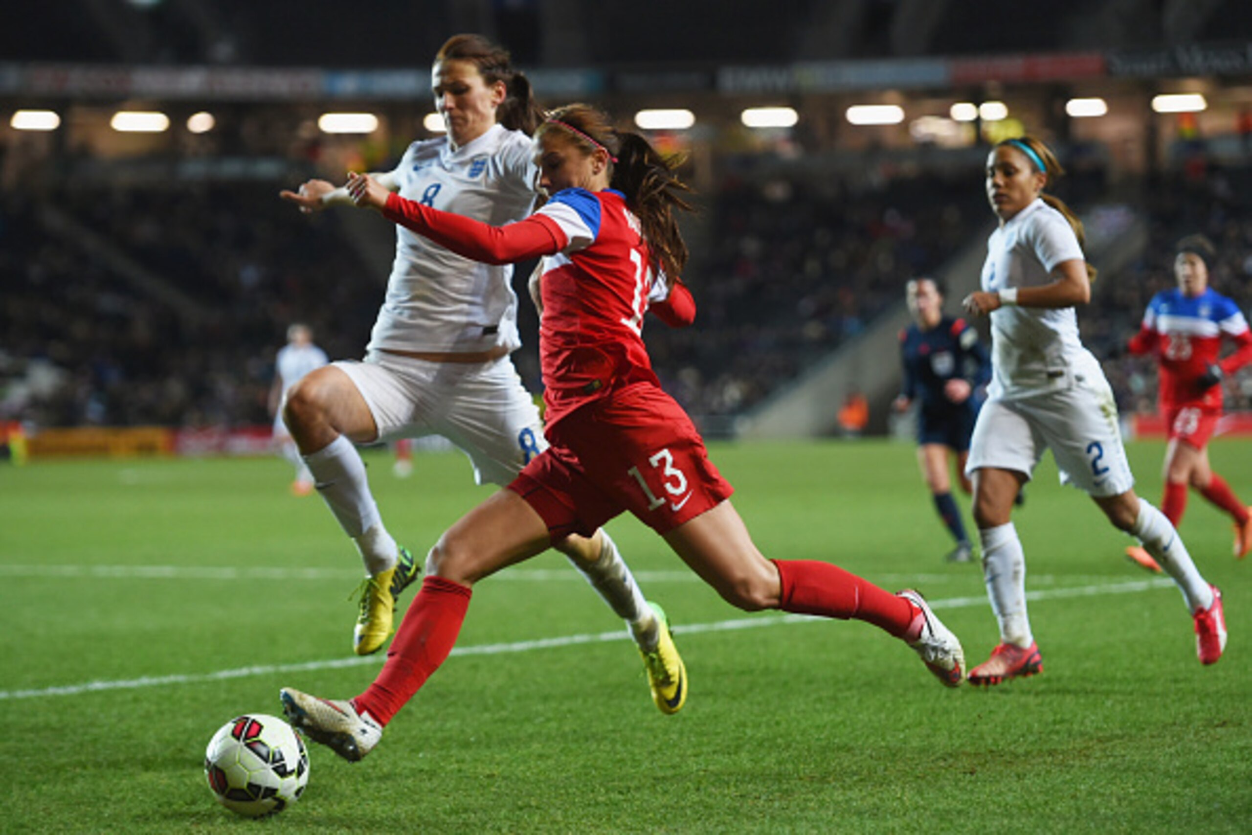 MILTON KEYNES, ENGLAND - FEBRUARY 13:  Alex Morgan of the United States takes on Jill Scott of England during the Women's Friendly International match between England and USA at Stadium mk on February 13, 2015 in Milton Keynes, England.  (Photo by Tom Dul