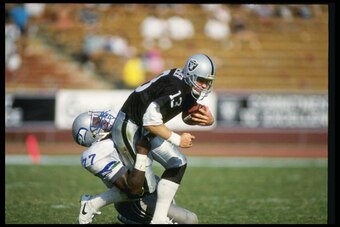 14 Oct 1990: Defensive linemen Jeff Bryant of the Seattle Seahawks sacks quarterback Jay Schroeder of the Los Angeles Raiders during a game at the Los Angeles Coliseum in Los Angeles, California. The Raiders won the game 24-17.