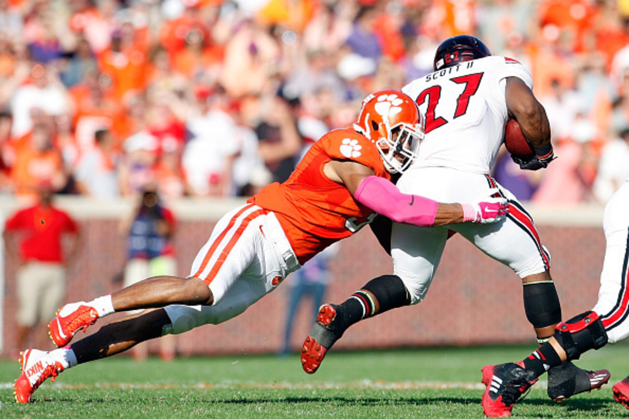 CLEMSON, SC - OCTOBER 11: Vic Beasley #3 of the Clemson Tigers makes a tackle on L.J. Scott #27 of the Louisville Cardinals during the game at Memorial Stadium on October 11, 2014 in Clemson, South Carolina. (Photo by Tyler Smith/Getty Images)