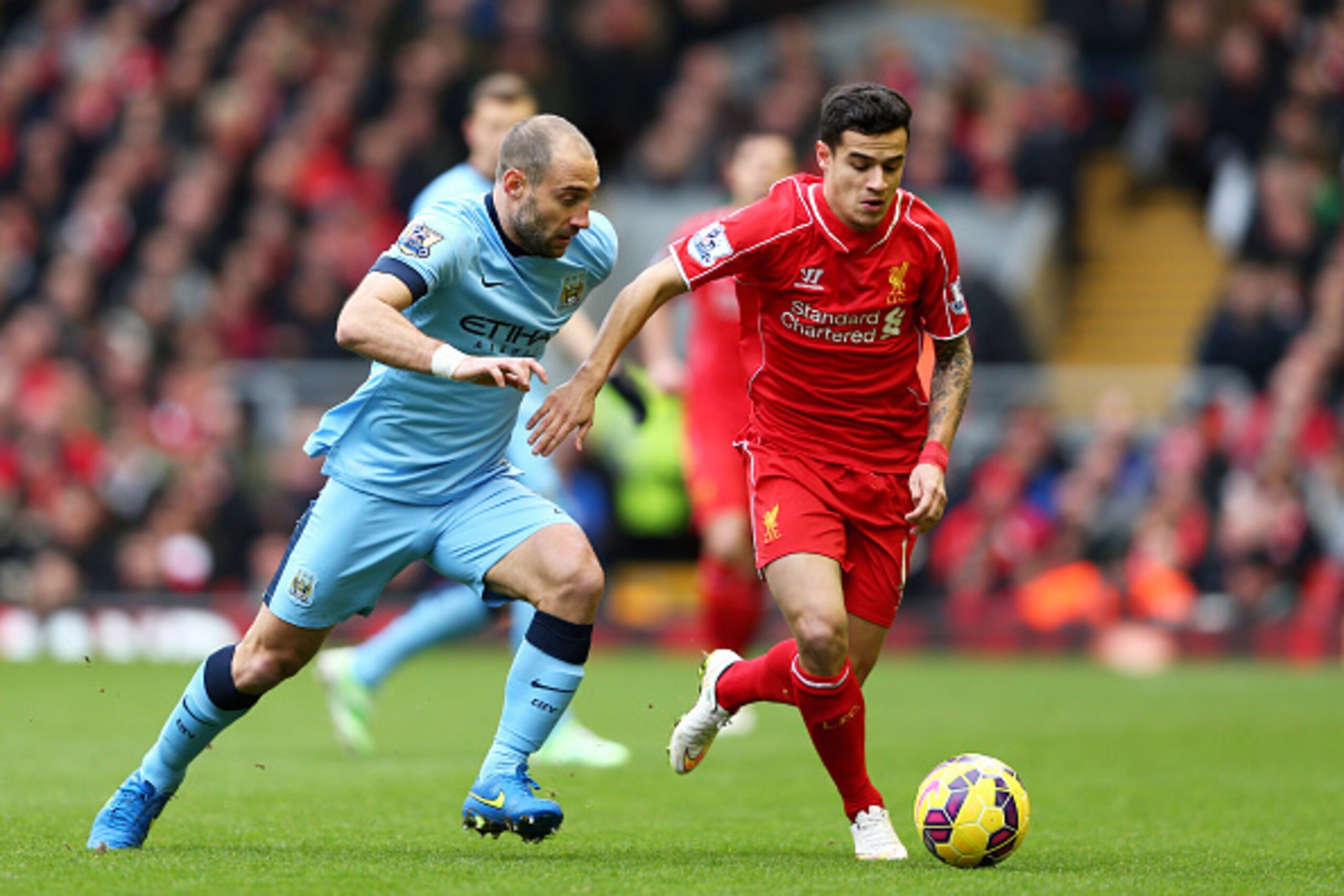 LIVERPOOL, ENGLAND - MARCH 01:  Philippe Coutinho of Liverpool is challenged by Pablo Zabaleta of Manchester City during the Barclays Premier League match between Liverpool and Manchester City at Anfield on March 1, 2015 in Liverpool, England.  (Photo by 