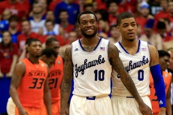 LAWRENCE, KS - JANUARY 18:  Naadir Tharpe #10 and Frank Mason #0 od the Kansas Jayhawks smile during the game against the Oklahoma State Cowboys at Allen Fieldhouse on January 18, 2014 in Lawrence, Kansas.  (Photo by Jamie Squire/Getty Images)