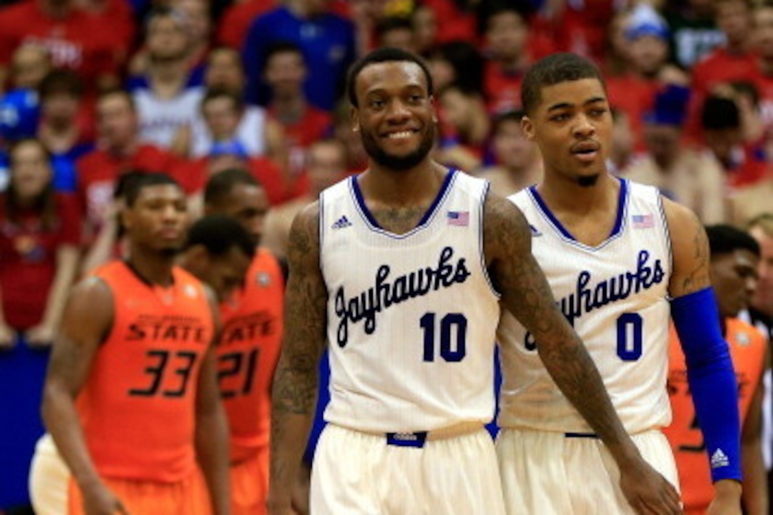 LAWRENCE, KS - JANUARY 18: Naadir Tharpe #10 and Frank Mason #0 od the Kansas Jayhawks smile during the game against the Oklahoma State Cowboys at Allen Fieldhouse on January 18, 2014 in Lawrence, Kansas. (Photo by Jamie Squire/Getty Images) LAWRENCE, KS - JANUARY 18: Naadir Tharpe #10 and Frank Mason #0 od the Kansas Jayhawks smile during the game against the Oklahoma State Cowboys at Allen Fieldhouse on January 18, 2014 in Lawrence, Kansas. (Photo by Jamie Squire/Getty Images)