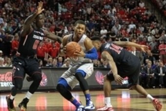 Feb 10, 2015; Lubbock, TX, USA; Kansas Jayhawks guard Frank Mason III (0) grabs a rebound in front of Texas Tech Red Raiders guard Devaungtah Williams (0) in the first half at United Supermarkets Arena. Mandatory Credit: Michael C. Johnson-USA TODAY Sport