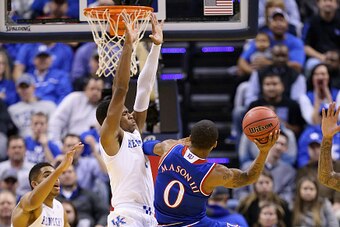 INDIANAPOLIS, IN - NOVEMBER 18:  Andrew Harrison #5 of the Kentucky Wildcats defends the shot of  Frank Mason III #0 of the Kansas Jayhawks in the State Farm Champions Classic at Bankers Life Fieldhouse on November 18, 2014 in Indianapolis, Indiana.  (Pho