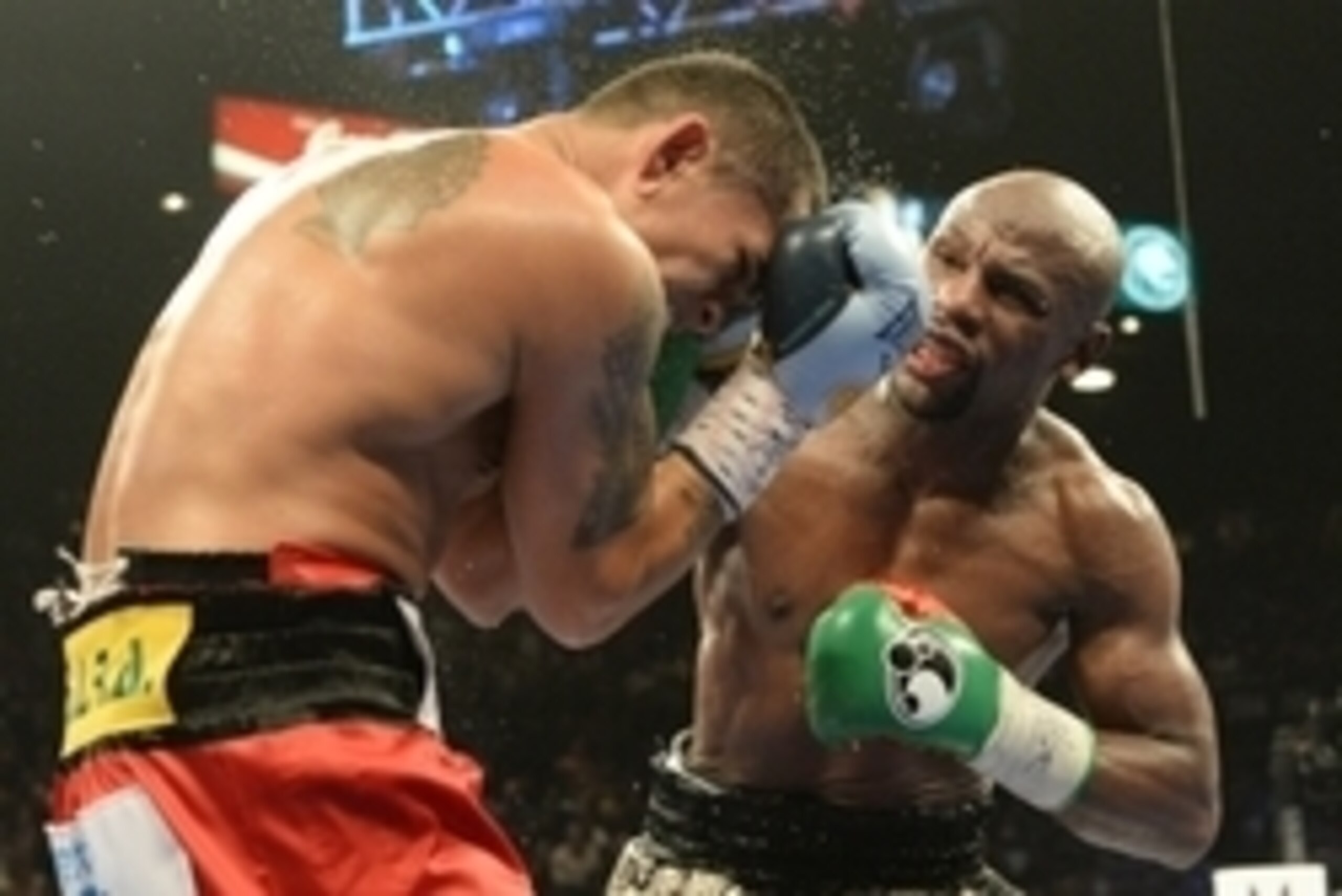 Sep 13, 2014; Las Vegas, NV, USA; Floyd Mayweather (green gloves) and Marcos Maidana (blue gloves) fight during their WBC & WBA Welterweight and WBC Superwelter Weight title bout at the MGM Grand Garden Arena. Mandatory Credit: Jayne Kamin-Oncea-USA TODAY