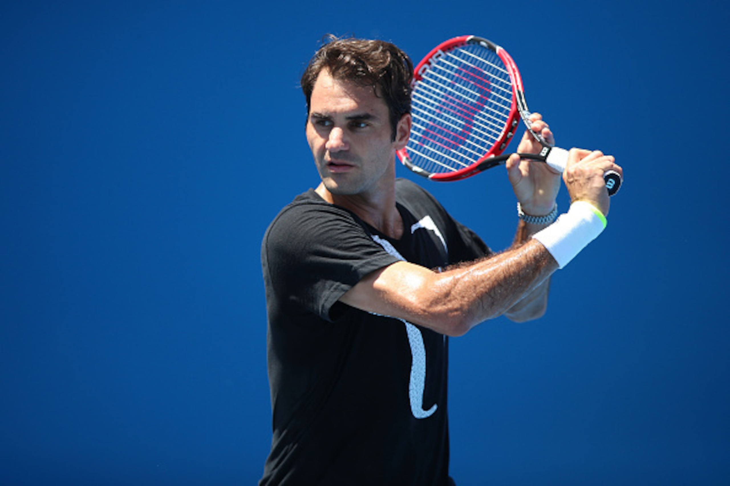 MELBOURNE, AUSTRALIA - JANUARY 22:  Roger Federer of Switzerland plays a backhand in a practice session during day four of the 2015 Australian Open at Melbourne Park on January 22, 2015 in Melbourne, Australia.  (Photo by Hannah Peters/Getty Images)